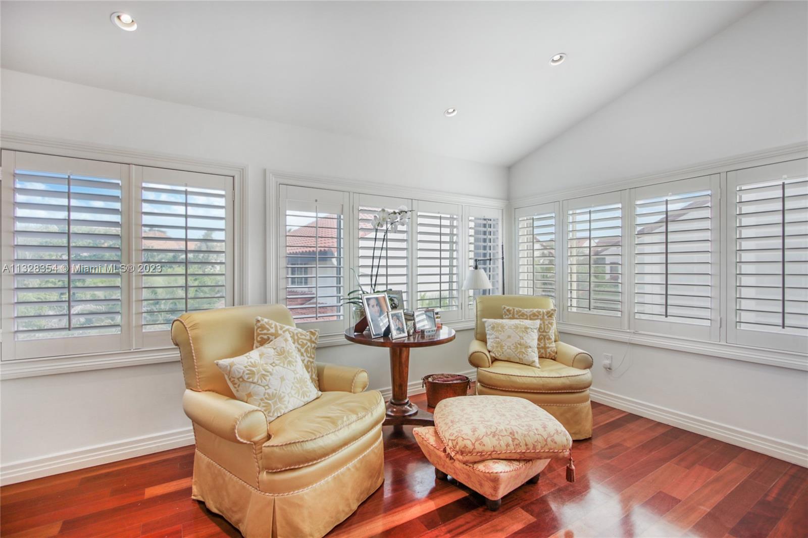 Master Bedroom sitting area with lovely views and light. Plantation shutters act as black-out screens in the AM