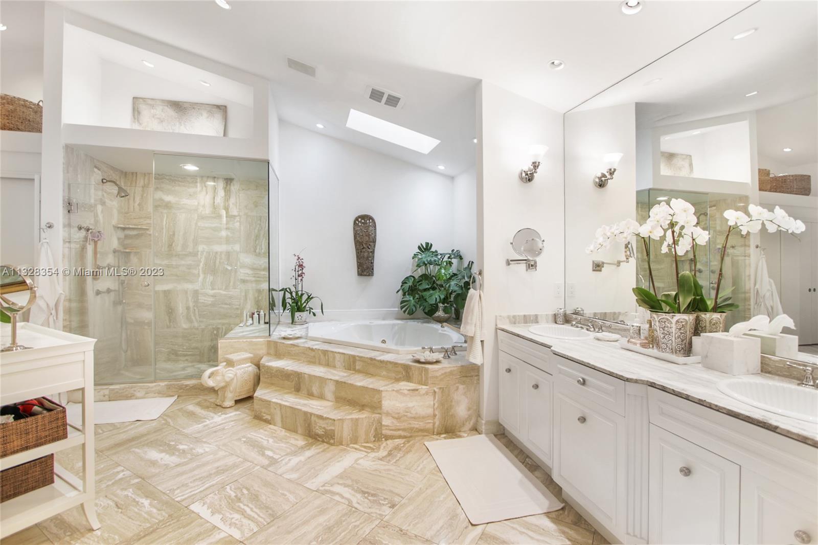 Very large Master Bath with volume ceilings, features skylights, a two-person hydro tub spa, separate shower, water closet with bidet, and three large closets