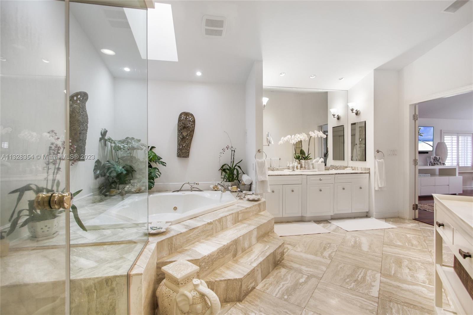 Very large Master Bath with volume ceilings, features skylights, a two-person hydro tub spa, separate shower, water closet with bidet, and three large closets