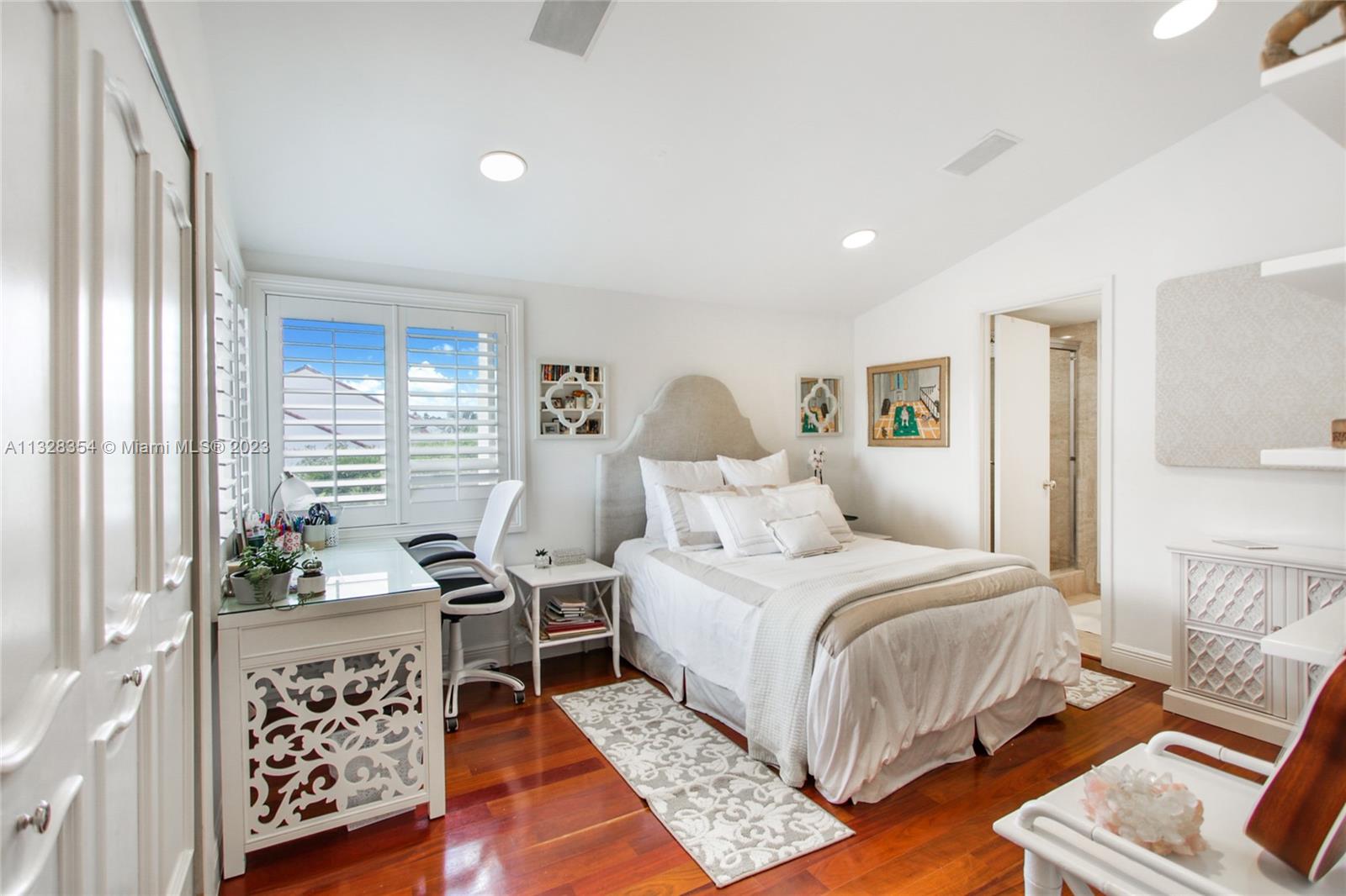 Leading down a long gallery hallway is 2nd. bedroom and bath, with high ceilings and quaint corner windows