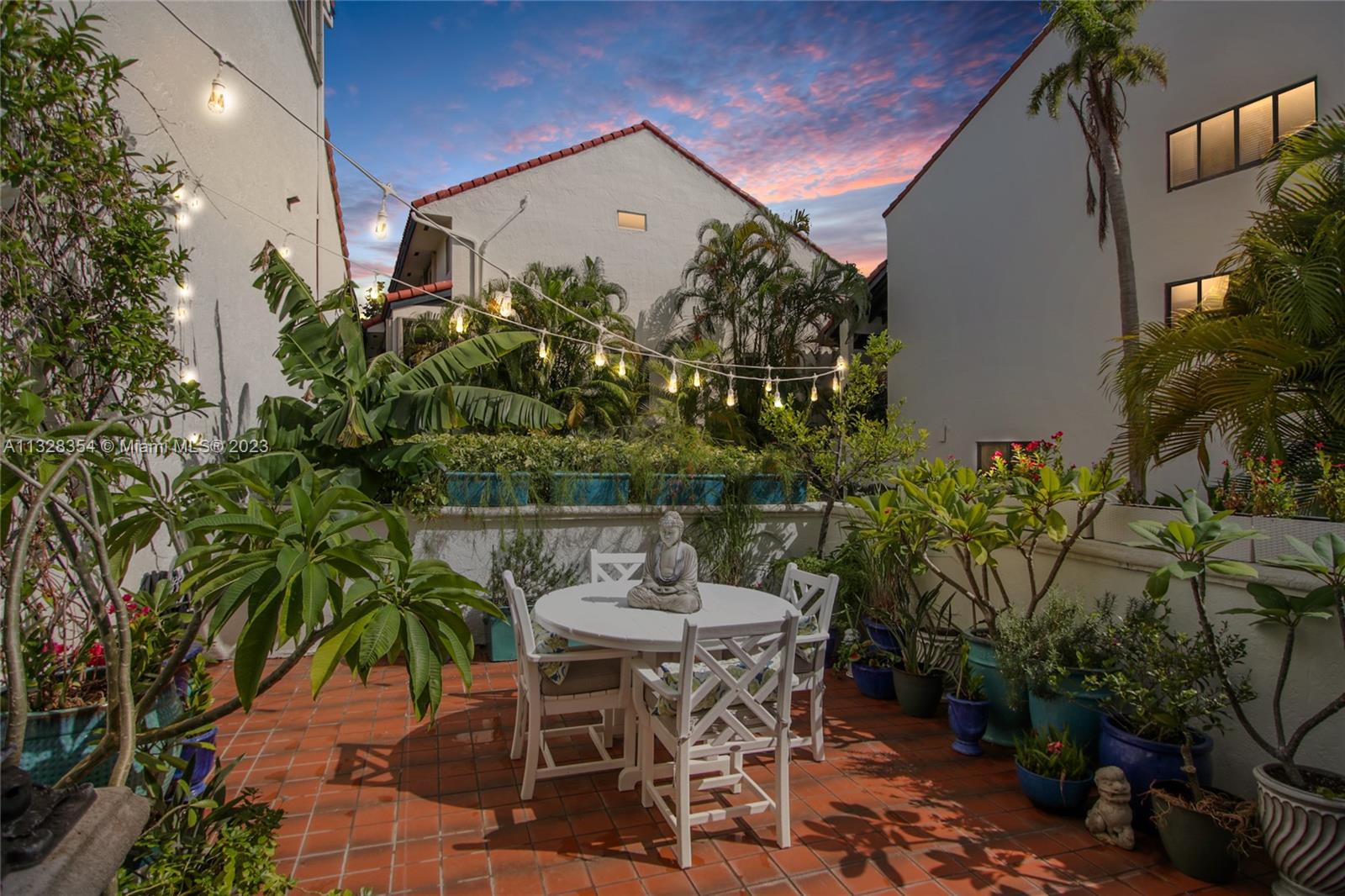 Lit up at night, this charming patio is great for relaxing at the end of the day, listening to the sound of the aquascape