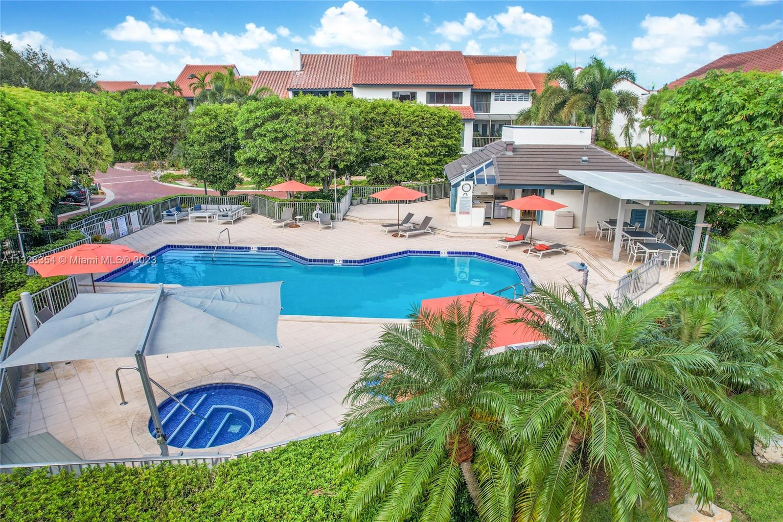 Great salt-water community pool and hottub, sauna, lounge chairs and umbrellas, covered area with tables and seating for dining, outdoor kitchen, grill, refrigerator. Great community vibe, too!