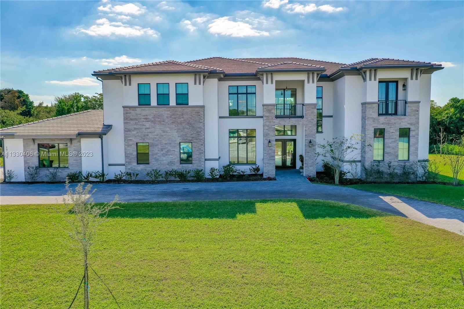 7,906 SQFT LIVING UNDER AC AND 8,509 SQFT LIVING AND GARAGE! 9,876SQFT LIVING/GARAGE/BALCONIES AND COVERED LENAI. OVER AN ACRE, RECENTLY BUILT IN 2021 2-story home in exclusive 10 home community, Terra Ranches in Southwest Ranches! Features a foyer that leads to a formal living area with large impact windows which open up completely and tuck away inside the walls leading to pool area. Large kitchen with high-end JennAir appliances. Full bar. Master bedroom on the first floor with a sitting area. Custom walk-in closet shelving. Elevator. Theater room with complete set up currently used as an office. Exterior back features expansive Lenai with retractable shutters, summer gas kitchen, and Californo pizza oven. Walk-in pool with hot-tub.