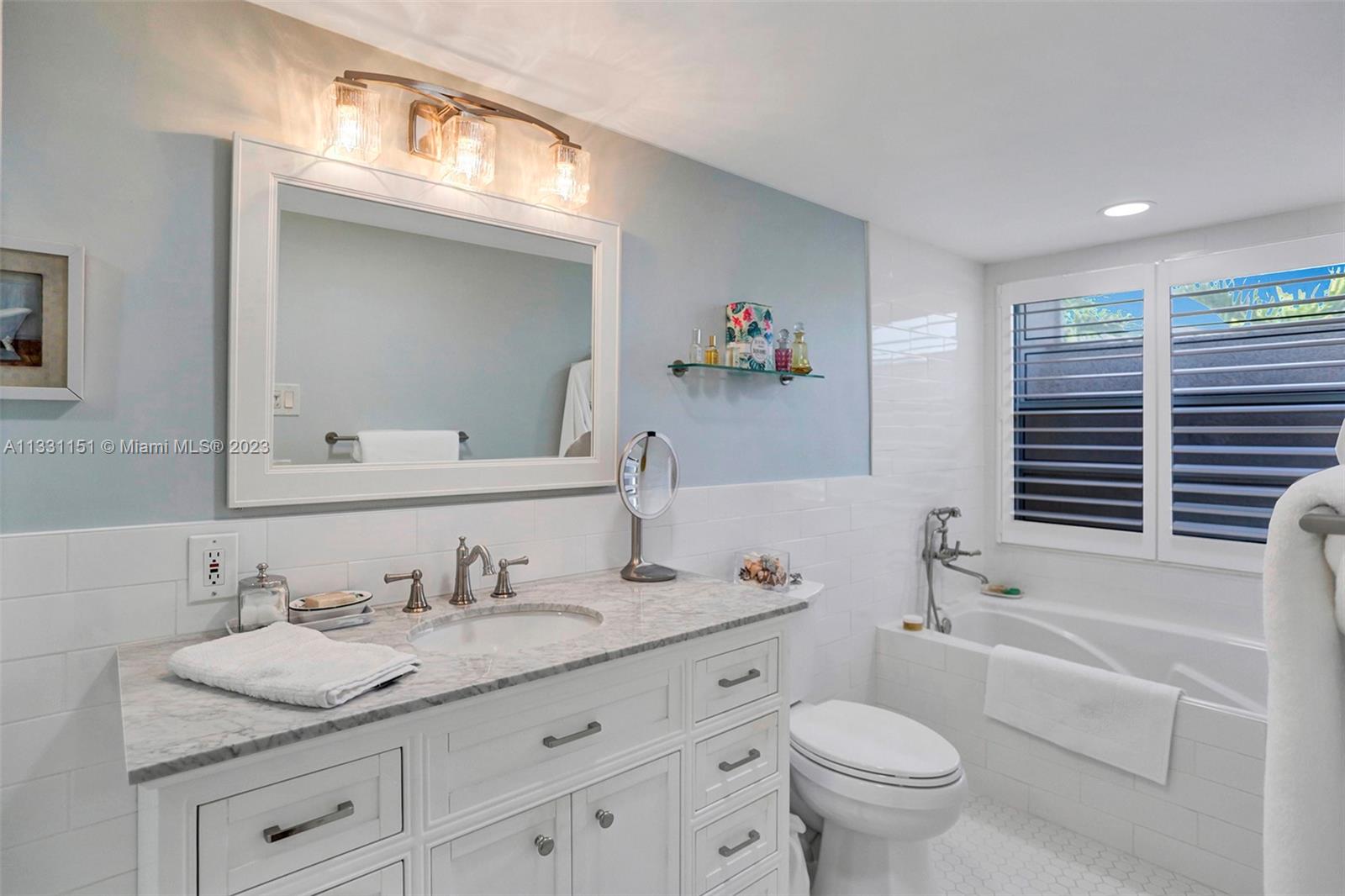 Brand new, fully renovated ,spa-like primary bathroom with glass enclosed shower & spacious bath