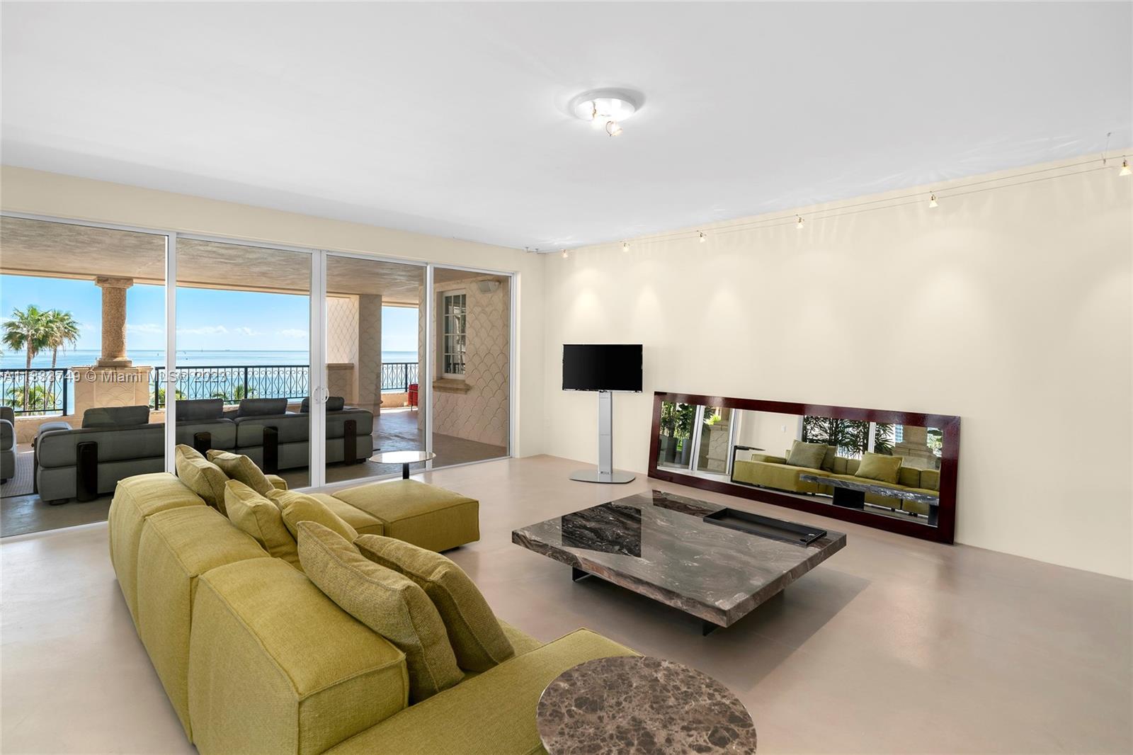 Watch the sunrise and enjoy the ocean breezes from this spacious Northeast oceanside corner unit. Features 3BR/4+1BA and 3,959 SF with an open living and dining layout surrounded by walls of glass and direct access to an expansive wraparound terrace with comfortable seating areas that offer views to Miami Beach, Government Cut and the Atlantic Ocean. A large open kitchen sports granite countertops, a rolling center island, Gaggenau appliances and a separate breakfast area. The private principal suite features a seating area, direct access to the oceanside terrace, dual walk-in closets and dual bathrooms. The 2 other bedrooms are each spacious with en-suite bathrooms and share a terrace with views to Fisher Island. Enjoy 5-star Fisher Island amenities.
