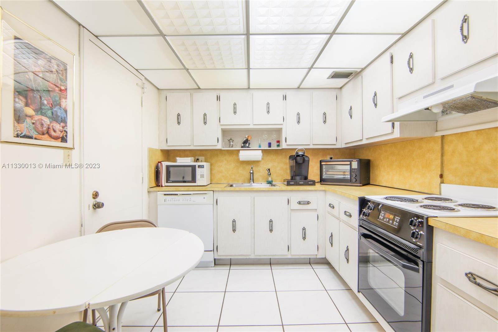 Virtually staged kitchen, of what it can be. One can redo the kitchen and open it up to the living room.