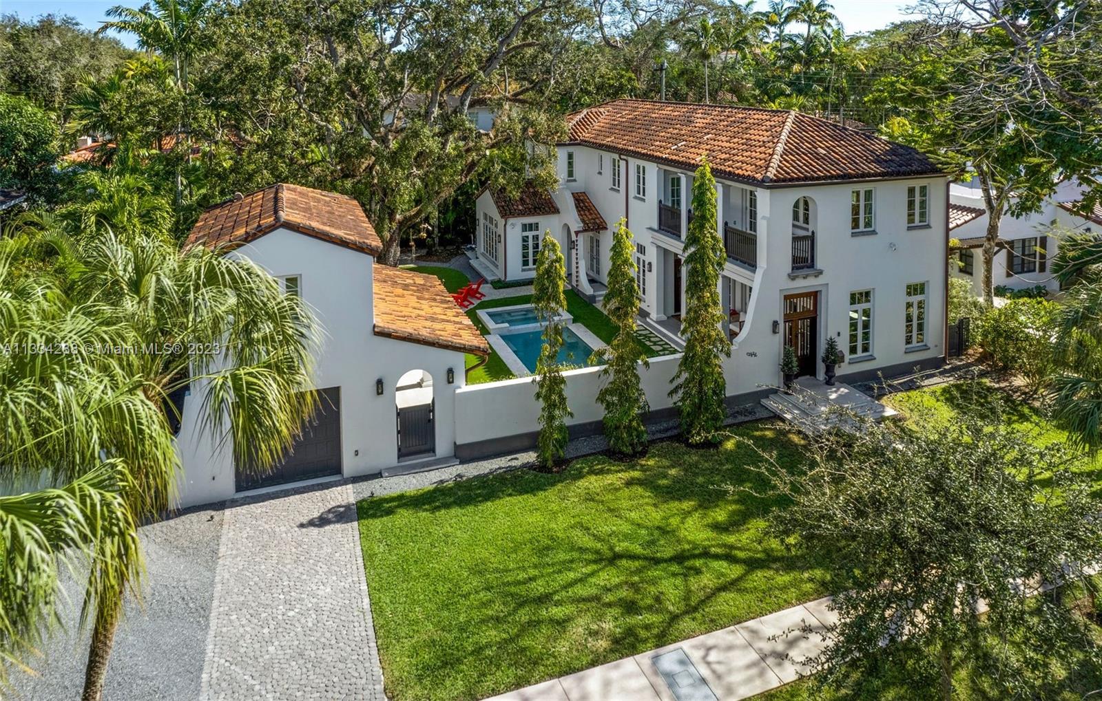 Located on prestigious North Greenway Drive in Coral Gables, the 5-bedroom, 5/1-bathroom main residence and charming guest house was the 2019 recipient of the notable Addison Mizner ICAA architectural award. The award-winning 4,813 SF home is situated on a sizable 11,000 SF lot. An impressive gourmet kitchen offers top-of-the-line appliances with a Wolf gas range and double oven, Sub-Zero refrigerator, freezer, and wine fridge. The expansive primary bedroom suite includes a separate seating area, kitchenette, and an oversized walk-in closet. The outdoor entertainment area features a beautiful heated saltwater pool with spa and a fully-equipped summer kitchen with built-in barbecue. Additional features include a whole house generator and covered terraces overlooking the backyard.