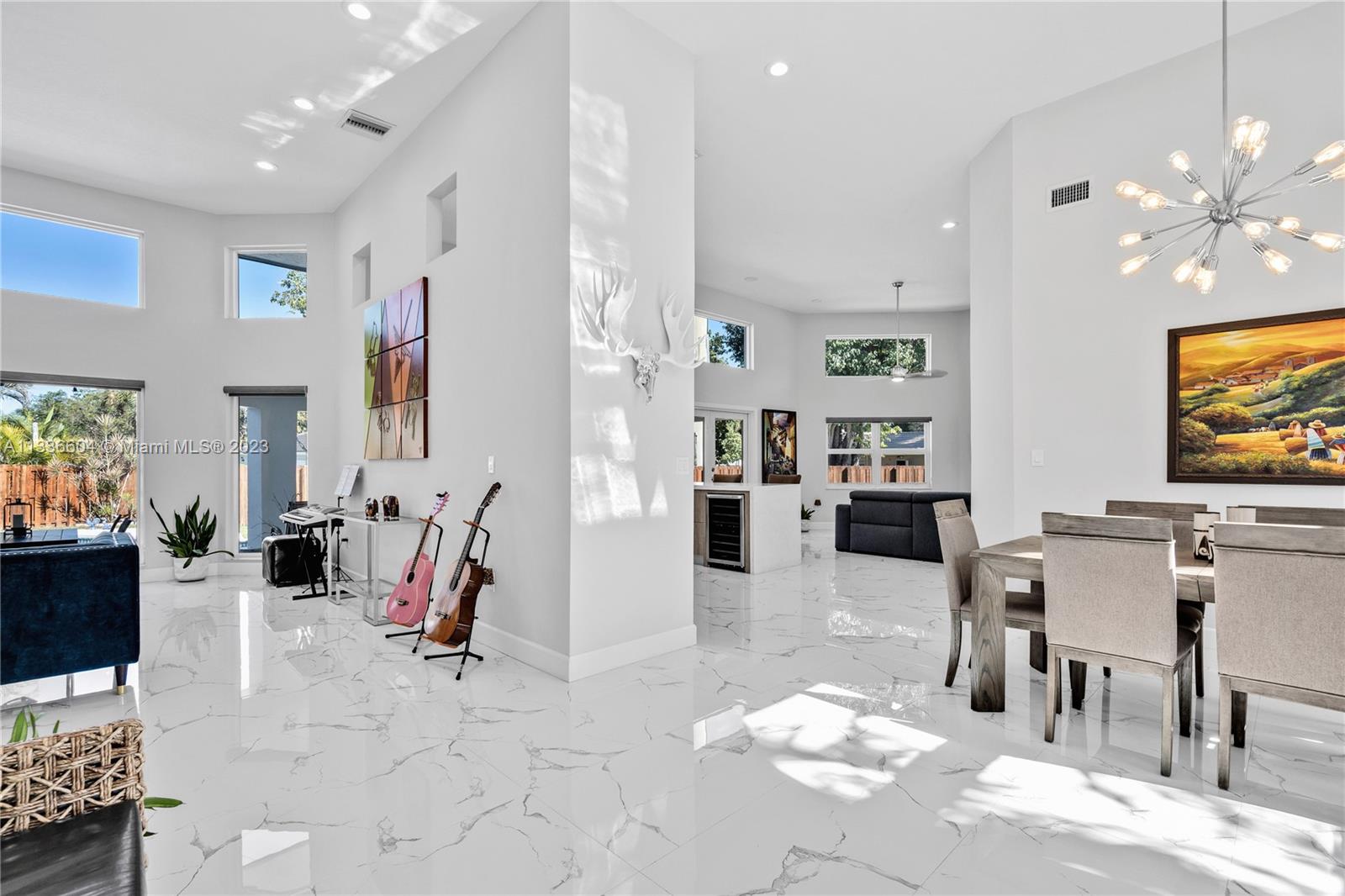 Fully remodeled, turnkey home in Palmetto Bay! Updated in 2019 with upscale finishes and flawless attention to detail that is reflected throughout the home. Light and bright, this home boasts 14ft ceilings in the main living areas, Italian designer flooring, sleek modern kitchen with Italian stone countertops, impact windows and doors that allow an abundance of natural light, and a spacious patio overlooking the sparkling pool and private fenced backyard which is perfect for outdoor entertaining.  Lavish primary suite with a gorgeous en-suite and walk-in closet.  Three additional family bedrooms, cabana bath, laundry room, oversized 2 car garage and a brand new metal roof.  Fabulous location in close proximity to top rated public and private schools, local parks, restaurants and shopping.