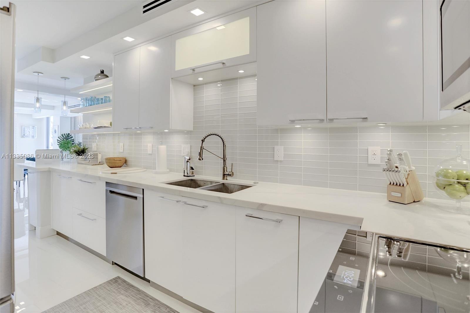 Custom Cabinets, Quartz Counters, Glass tile, Stainless Steel & Full lighting