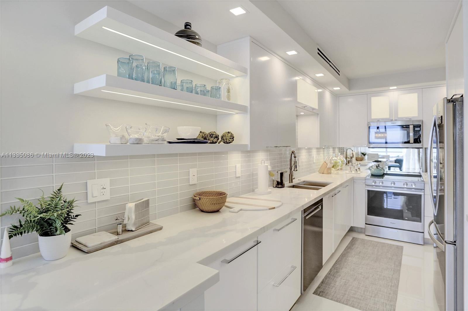 Custom Cabinets, Quartz Counters, Glass tile, Stainless Steel & Full lighting