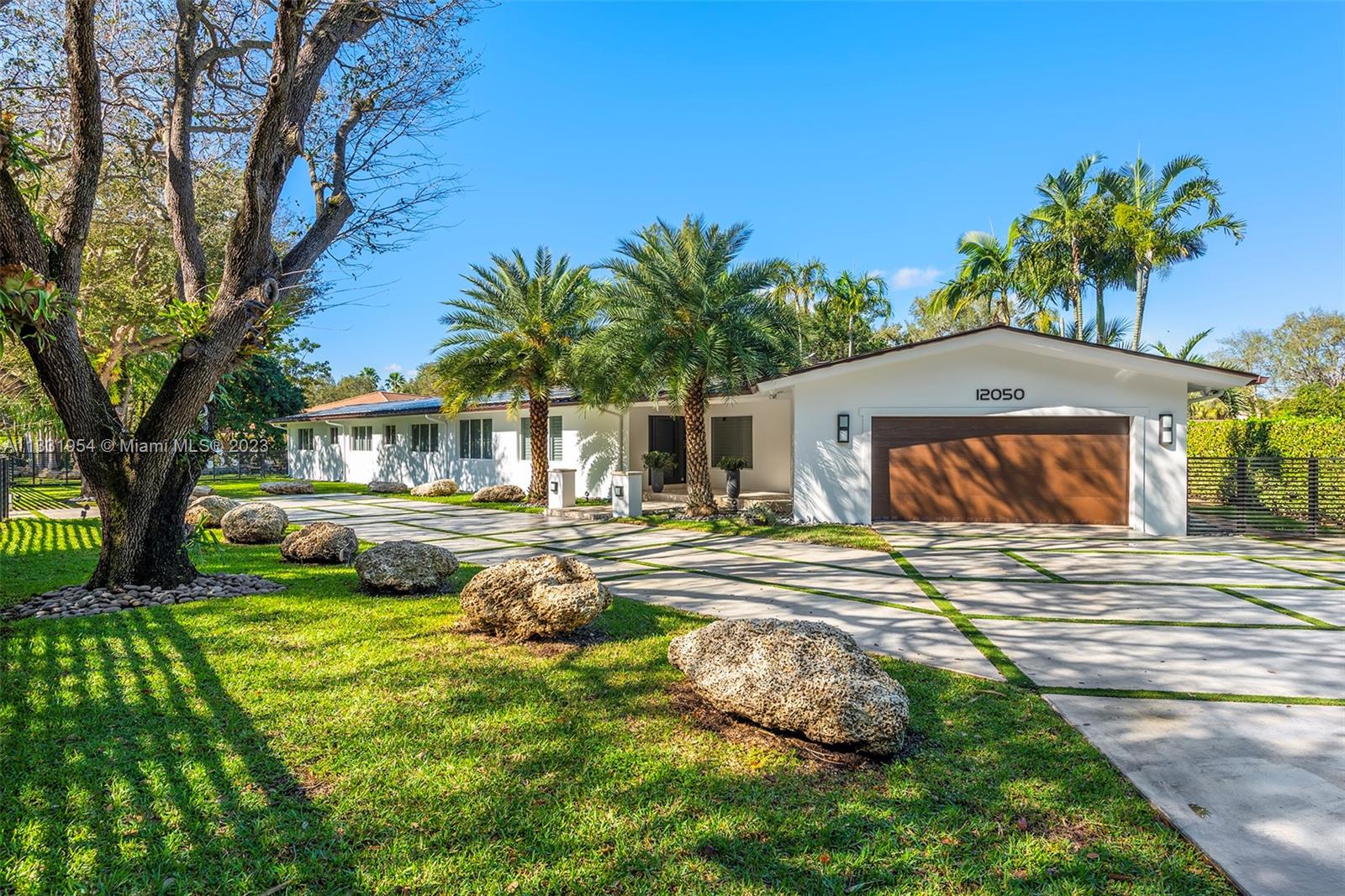 Completely and meticulously renovated contemporary home situated on an expansive 26,963 SF lot in the heart of Pinecrest. This turn-key luxury home features an open floor plan with spacious living room and dining area that open to a large covered terrace and a saline heated pool, perfect for year-round entertainment. Fabulous chef's kitchen features Italkraft wood, white lacquer cabinetry, stainless steel top of the line appliances, separate large laundry and storage room. This 4bd/4bath home offers ensuite guest bedrooms, a sumptuous primary bedroom with walk-in closet and beautiful bath. Enjoy swimming in the pool, playing a round of basketball or sitting in your backyard next to a natural waterfall grotto to calm the senses. 2 car garage w electric charger; Energy Saving Solar panels.