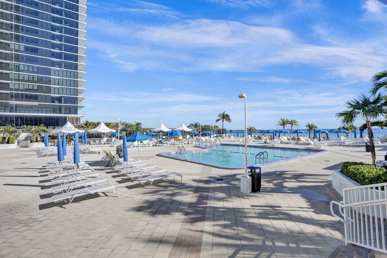 FULL SUNNY RESORT-STYLE POOL WITH DIRECT ON-THE-SAND OCEANFRONT LOCATION