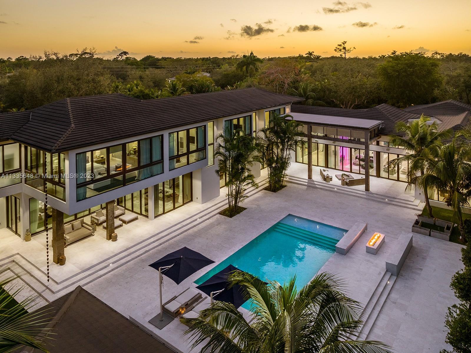 Modern Style meets unmatched elegance in this tropical paradise in N Pinecrest. This exquisite 2019 custom estate sits on over an acre & greets you w/multiple water features, grand foyer, volume ceilings & flr to ceiling white linen draperies. Unique open plan offering panoramic views of the outdrs from great rm. Quintessential kitchen by Officine Gullo w/walk-in pantry & Wolf/SubZero appl. This estate has it all w/state-of-the-art video & surround sound, home theatre, & sports bar rm. Bi-Level bedrms w/private sitting rms downstairs. Lavish master ste w/boutique WIC, sitting area, spa bath w/floating tub & 16ft shower. Outdr oasis w/pool, spa, covered terr, summer kit, outdr shower. Other Feat: elevator, maids rm, generator, 3 fire pits, 3 car gar w/space for lifts, elite schools nearby.