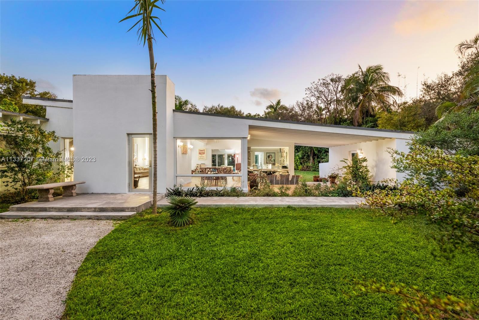 Introducing an extraordinary iconic example of mid-century modern architecture deftly combining the best of both worlds, the desirability of its location and the privacy of a property, with magnificent gardens, on a 39,465 SF lot. Meticulously renovated by current owners in 2015 the home features exquisite wide planks of imported Italian oak wood flooring, dark UV solar tinted impact glass, a formal dining room with garden views that help create a dreamy, floating existence.The well appointed eat in kitchen with top of the line appliances and family room open to a magical garden and glistening pool 8' at its deepest. 
The sprawling primary bedroom consists of oversize alcove, walk in closet, stunning tiled bath with soaking tub and transparent rain shower room. This home is a true gem.