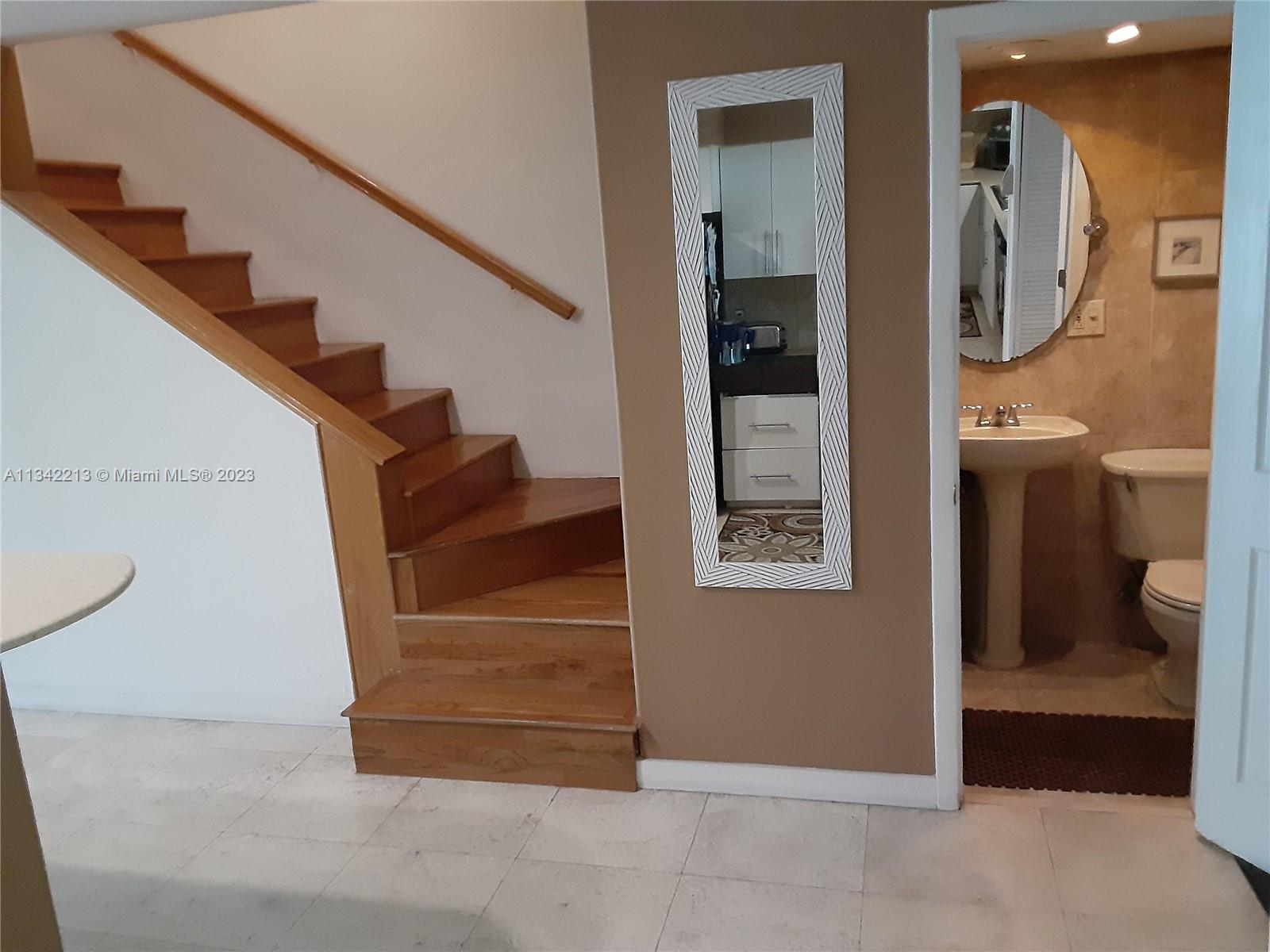 Stairs and 3rd full bathroom (1st level)