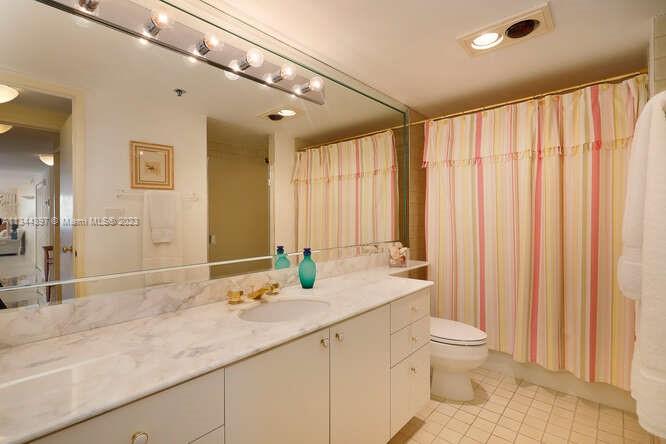 Guest bathroom features tub and separate shower.