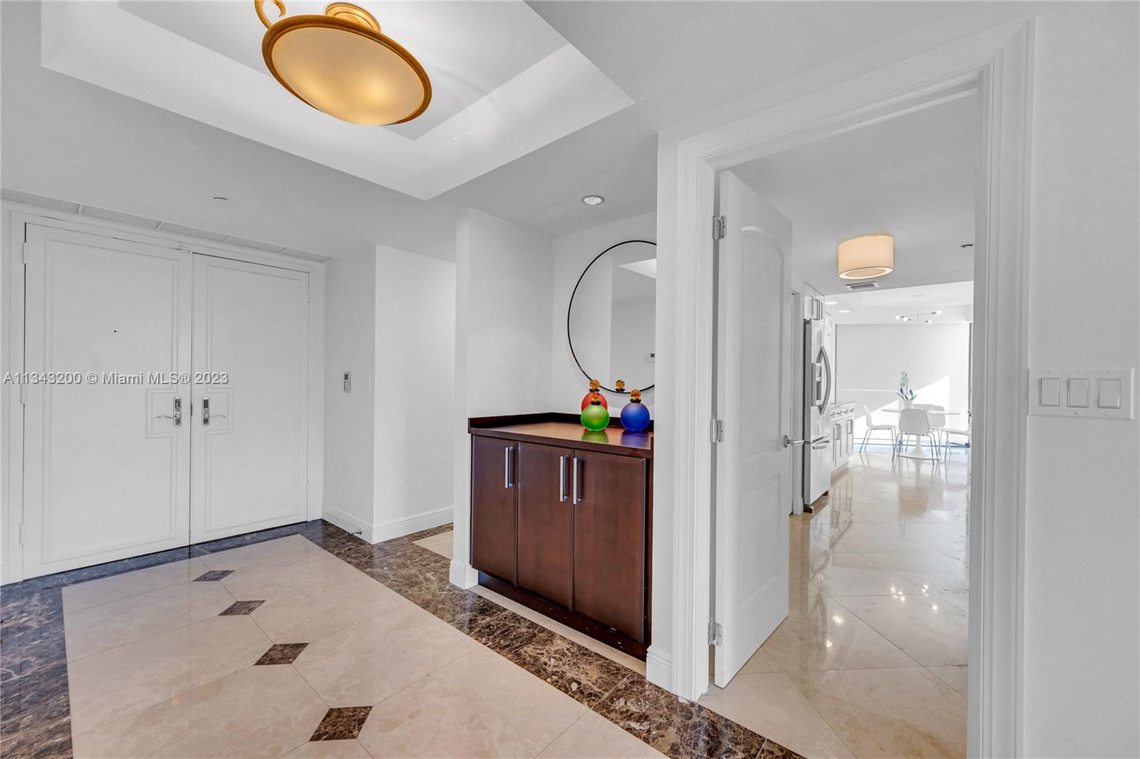 Foyer entry with entrance to kitchen viewd from inside
