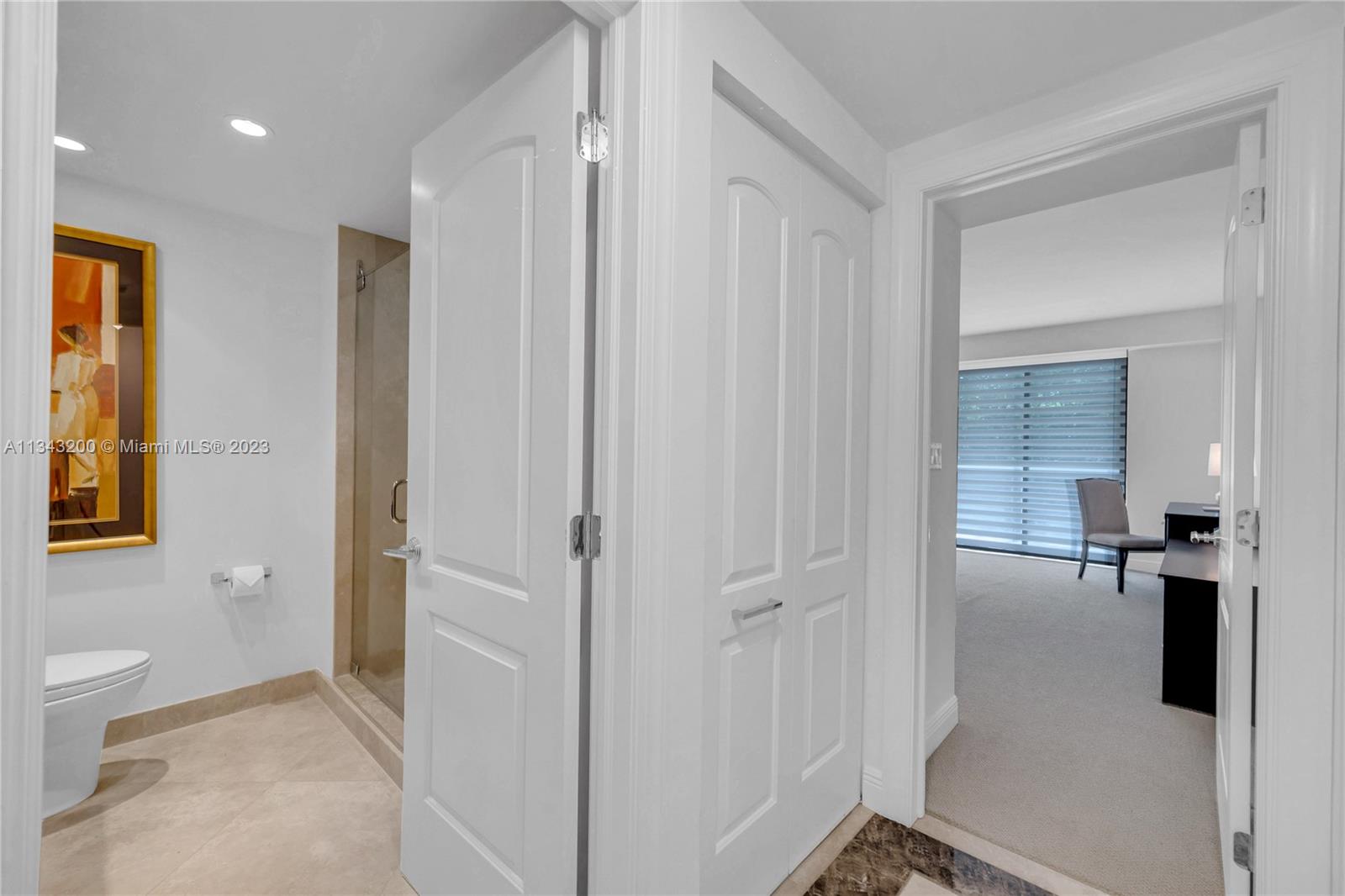 Hallway leading to guest bathroom and bedroom