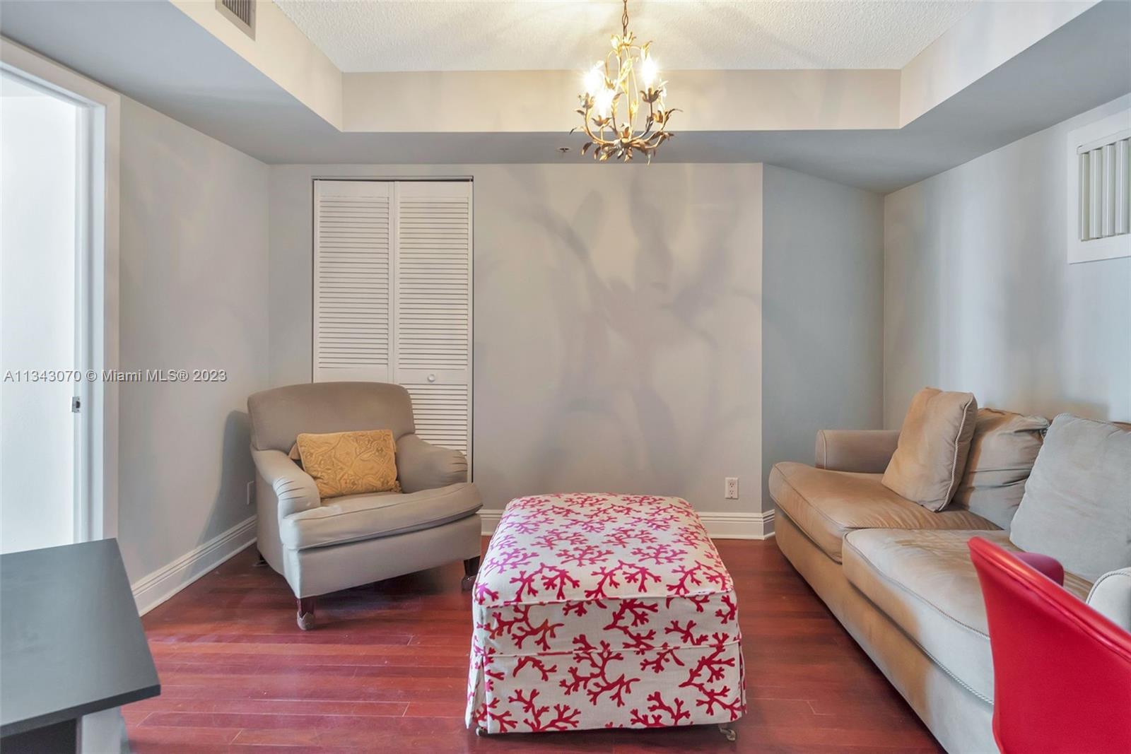 Washer/dryer closet in hallway off living room leading to second bedroom.