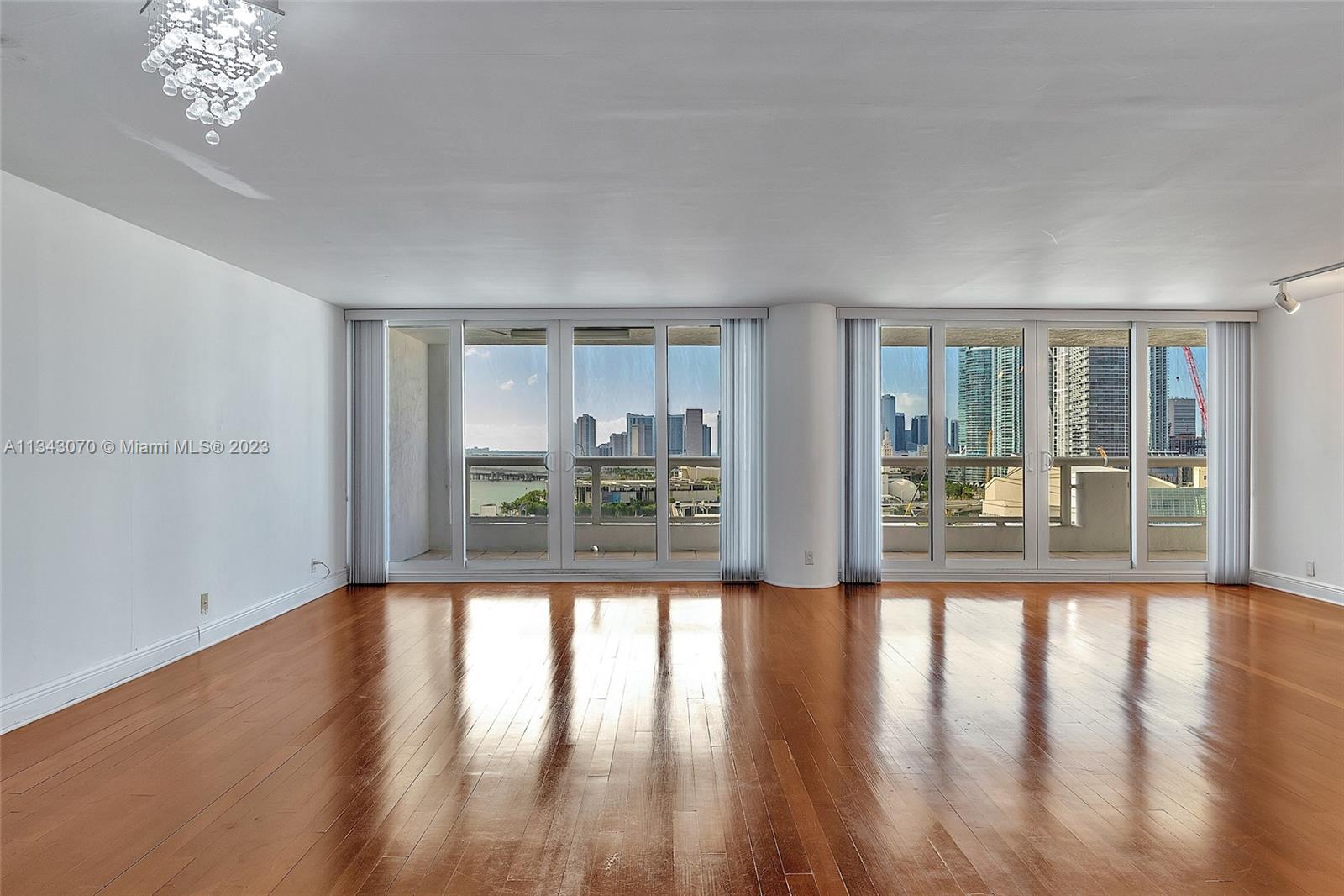 View to the south from the dining room with sliding impact glass doors leading to the 317 SF balcony.