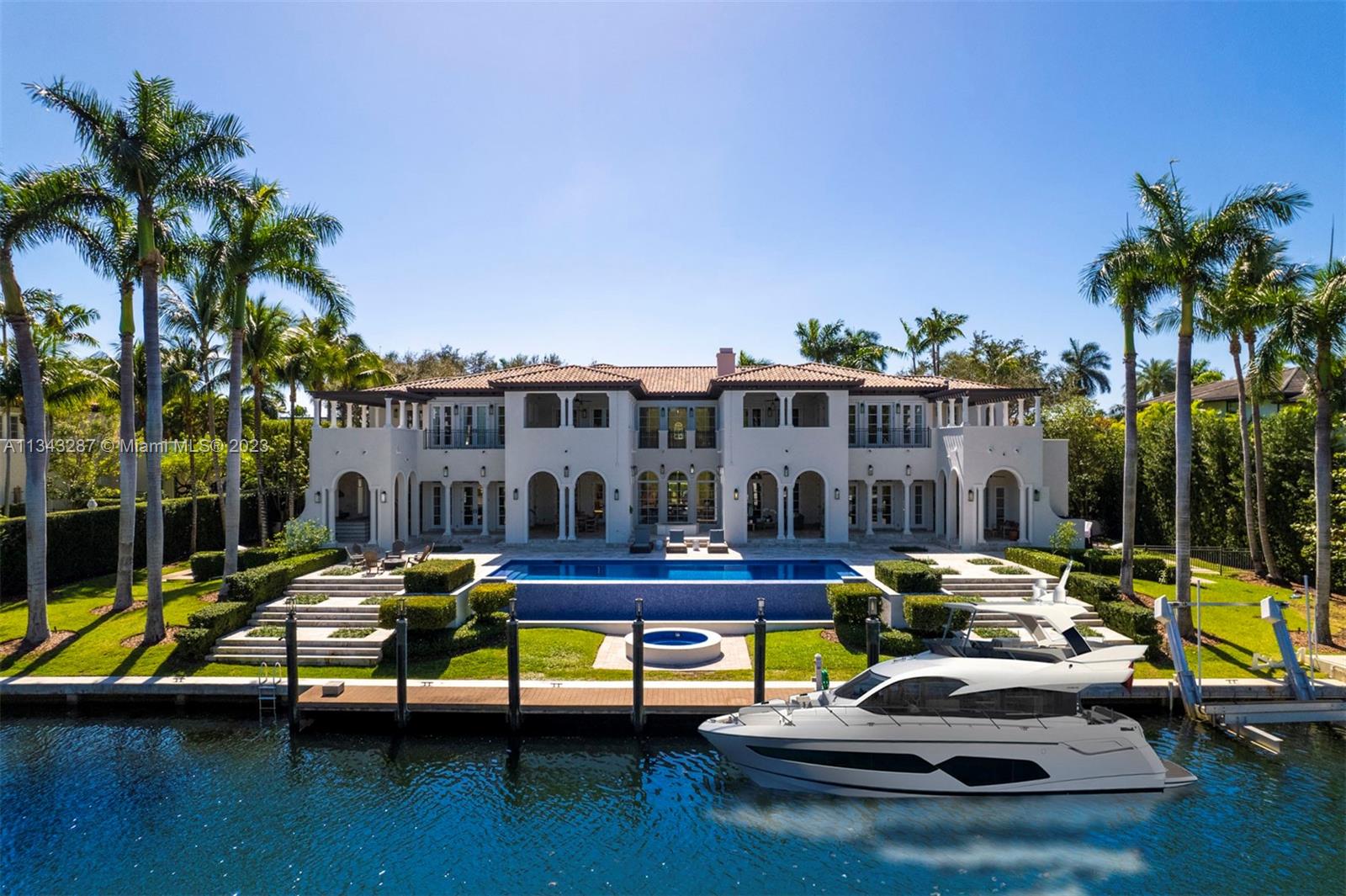 This exquisite 11,946 sq ft waterfront property, located in the highly sought-after Gables Estates, sits on an expansive lot with 180 ft of waterfrontage. Boasting 8 BR, 3 half BA, this impressive mansion is a work of art. The main suite features a private balcony, 2 walk-in closets, and luxurious spa-like bathroom. The home's open floor plan seamlessly connects the living, dining, and kitchen areas, making it ideal for both casual family living and large-scale entertaining. Outside, the property is beautifully landscaped and features cabana with sauna room, covered terraces, a summer kitchen, and a large infinity-edge pool. The home also has a private dock, making it easy to enjoy water activities right from your backyard. This home is sure to impress even the most discerning buyers.
