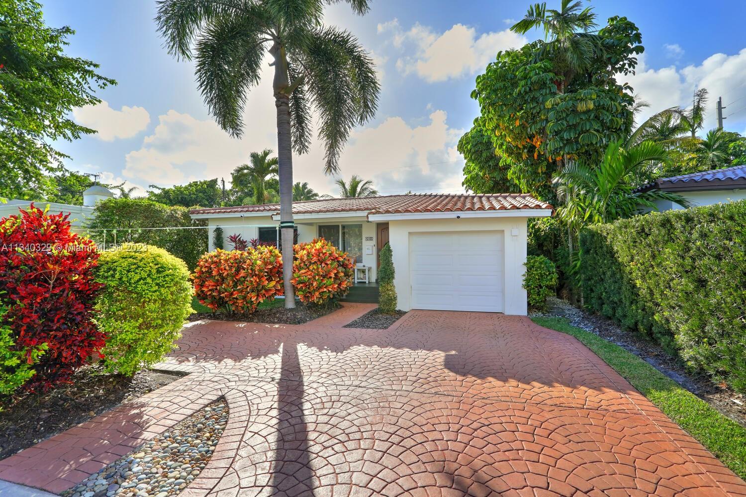 This stunning home in Coral Gables has undergone a modern renovation, making it an ideal choice for discerning buyers. The property includes 3 bedrooms & 2 bathrooms, & is located on a peaceful cul-de-sac. The interior features a recently updated kitchen & bathrooms, as well as hardwood & tile floors, hurricane impact windows, & a 2022 Trane A/C unit equipped with smart sensors, controls & UV light air purifier. In addition to a new electrical panel & tankless water heater, the home comes with brand new appliances, including a washer & dryer. The property's beautiful landscaping in the front & back yards adds to the sophisticated appeal, with the backyard featuring a new pergola & outdoor deck fitted with smart lights, which expands the outdoor living space by an additional 700 sqft.