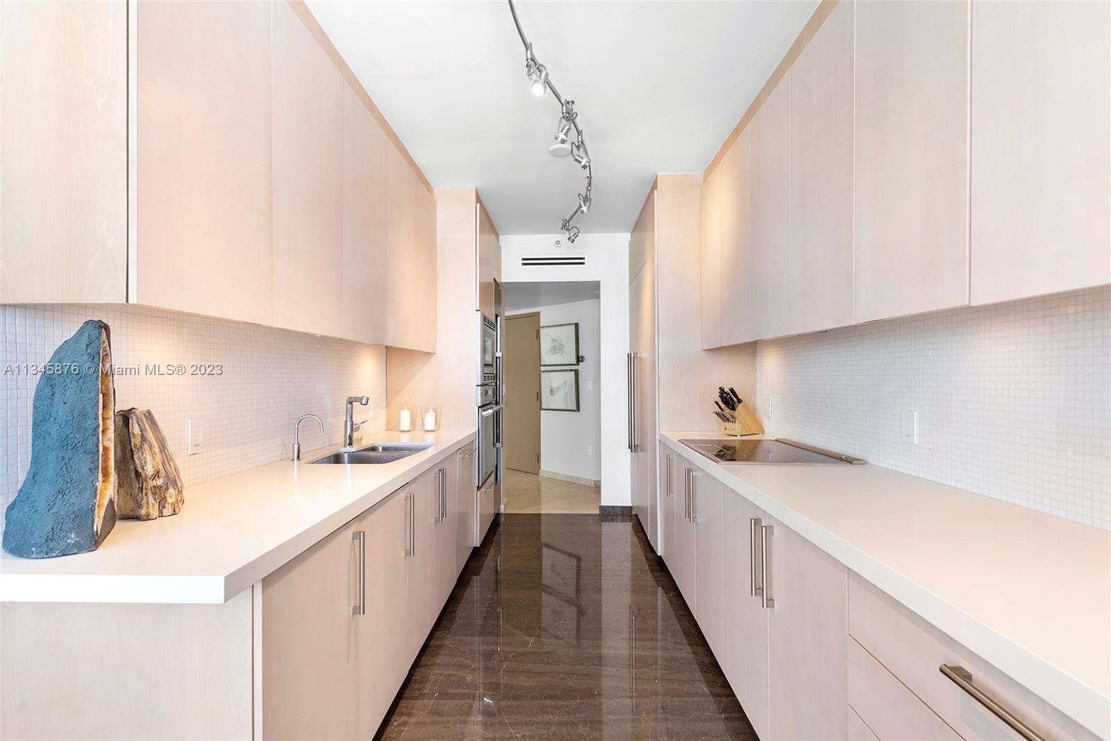 Kitchen with tall upper cabinets, Thermador appliances, and wine refrigerator