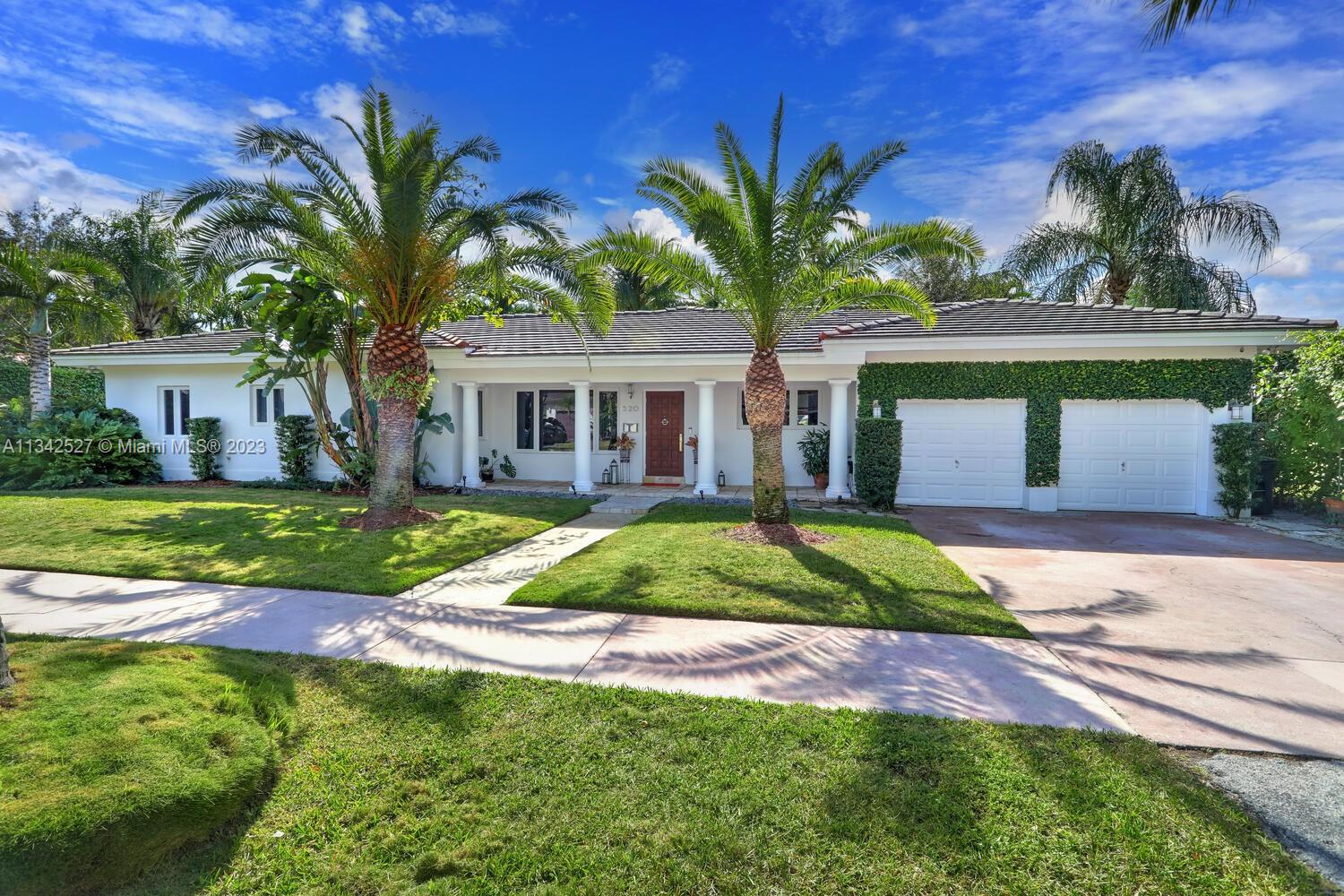 Lovely Bermuda-style inspired home set on large 12,500 sqft lot with lush tropical landscaping surrounding 25K gallon saltwater pool, located in the highly coveted South Gables neighborhood. Completely rebuilt in 2005 according to the South Florida Building Code including new roof, impact glass casement windows and doors, and all new interior infrastructure. This beautiful home features open floor light-filled living spaces with cathedral wood ceiling, elegant Crema Marfil marble flooring and stunning views of the pool and secluded garden area. Modern-style kitchen with wood cabinetry, quartz countertop and energy saving stainless steel appliances. Ample land for home expansion. Home features ADT/Ring alarm system with closed circuit cameras and large air conditioned two car garage.