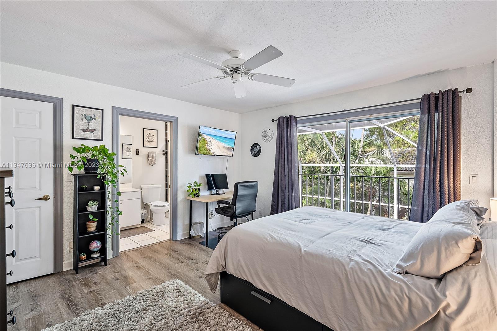 Primary Bedroom ensuite bathroom with sliders doors to patio/lanai and two walk in closets.