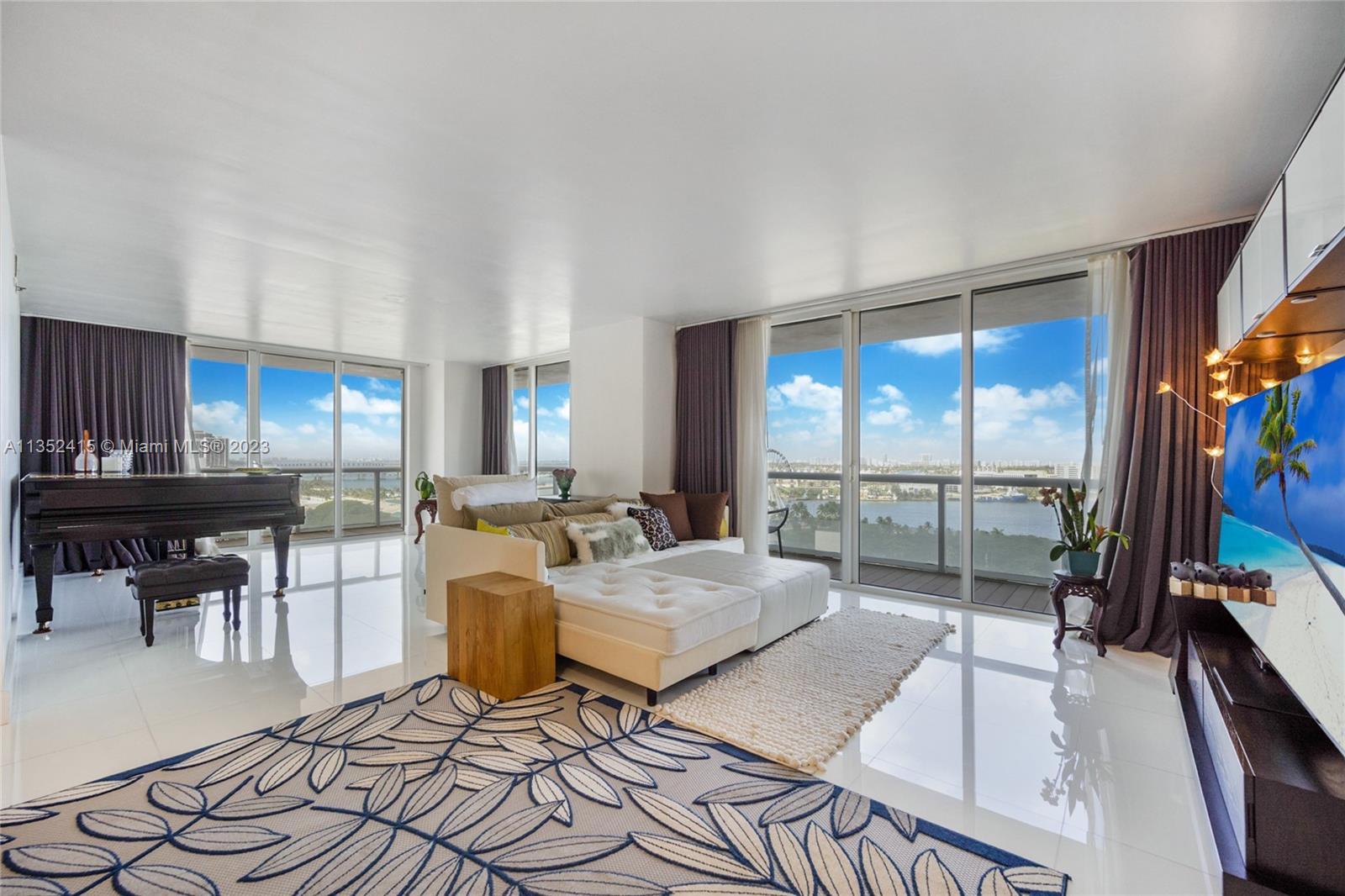 Best corner line and view in building. All living areas and 3 bedrooms open to the wraparound terrace from  which to enjoy unobstructed NE views of the Bay, Bayfront Park, Skyviews Wheel, cruise ships setting sail and much more. 
The unit has been upgraded with pristine 24 in x24 white marble floors, onyx detailing and rain, hand held and double shower heads in main bathroom, glass shower enclosures, 2 walk ins in main bedroom, durable wood-look terrace deck, black outs in all rooms, custom bath mirrors, Toto built in bidets, built ins, full size washer and dryer. 1 assigned space and  enjoy  pool, gym, front desk services and valet in the heart Miami’s vibrant Bay front Downtown.