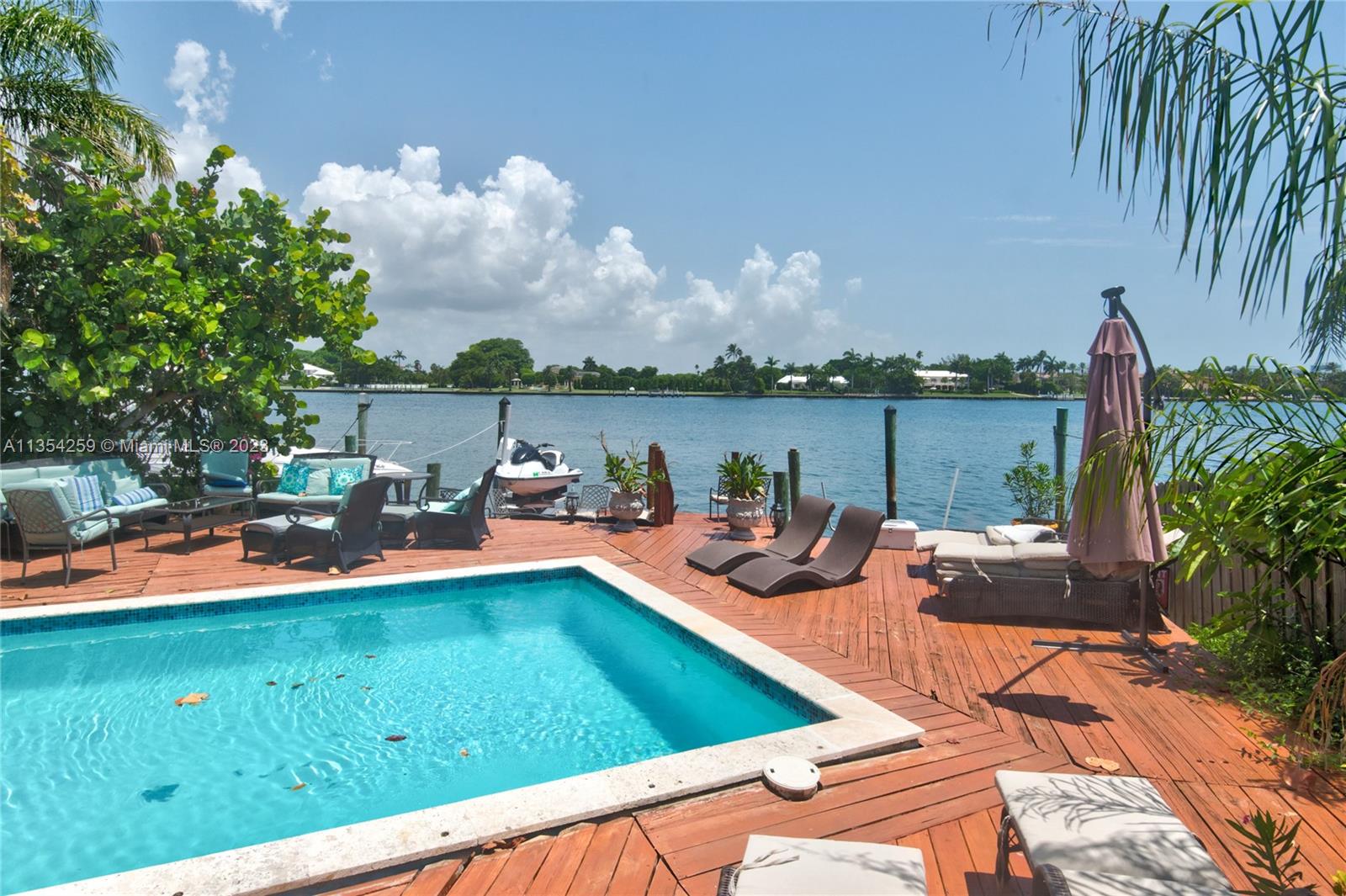 Waterfront 4/4 pool home with panoramic bay view on a private peninsula with a guard gate and a one car garage. Beautiful wide bay views with Indian creek mansions across the bay.
