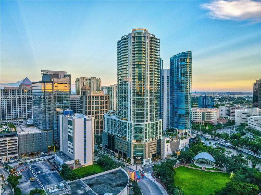 IN TOWN LAS OLAS LUXURY LIVING WITH VIEWS to EVERYWHERE - This is what you've dreamed of - ALMOST 3000sqft of LUXURY- Relax on your HUGE wraparound covered terrace, enjoying amazing SUNSETS over the BEST NW views of the RIVER, PARK & CITY. This SPACIOUS, GORGEOUS MODERN home is PERFECT, featuring 3 Split Bedrooms, 3.5 baths PLUS DEN (Office, 4th Bed, or flex space). Top of the line European finishes. New motorized shades in every room! Come home & unwind at the height of elegance with a Resort Lifestyle. Private Concierge front desk, 24 hour security, BBQ, rooftop pool, club room, gym, treatment room & more. 2 COVETED SECURE PARKING SPACES! Eddie V's and Harborwood in the building! - PET FRIENDLY. Las Olas Shopping, dining, entertainment is right outside your door. This building is a 100!