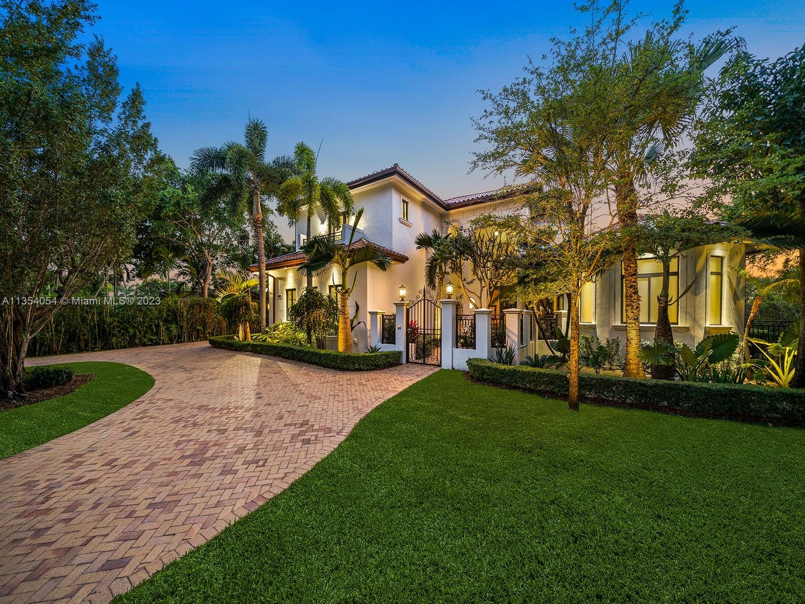 This Magnificent two-story estate in N Pinecrest welcomes you w/lush landscaping & a private gate entrance w/ charming courtyd that sets the tone for this exceptional property. Upon entering, you'll be awed by the soaring ceilings, grand foyer, & sweeping formal living rm. Spacious gourmet kitchen elegantly overlooks the expansive family rm, accentuated by its double height ceilings, complete w/top-of-the-line Viking/SubZero appl & a walk-in pantry. Expansive living areas create the perfect space for entertaining guests, w/ a home office & a second family rm upstairs w/wet bar. The primary suite is a true sanctuary w/spa-like bath, sitting area & access to backyd. Discover outdr living w/covered terraces, large pool, spa & ample grounds. Add’l features: imp win/drs, generator & 3-car gar.