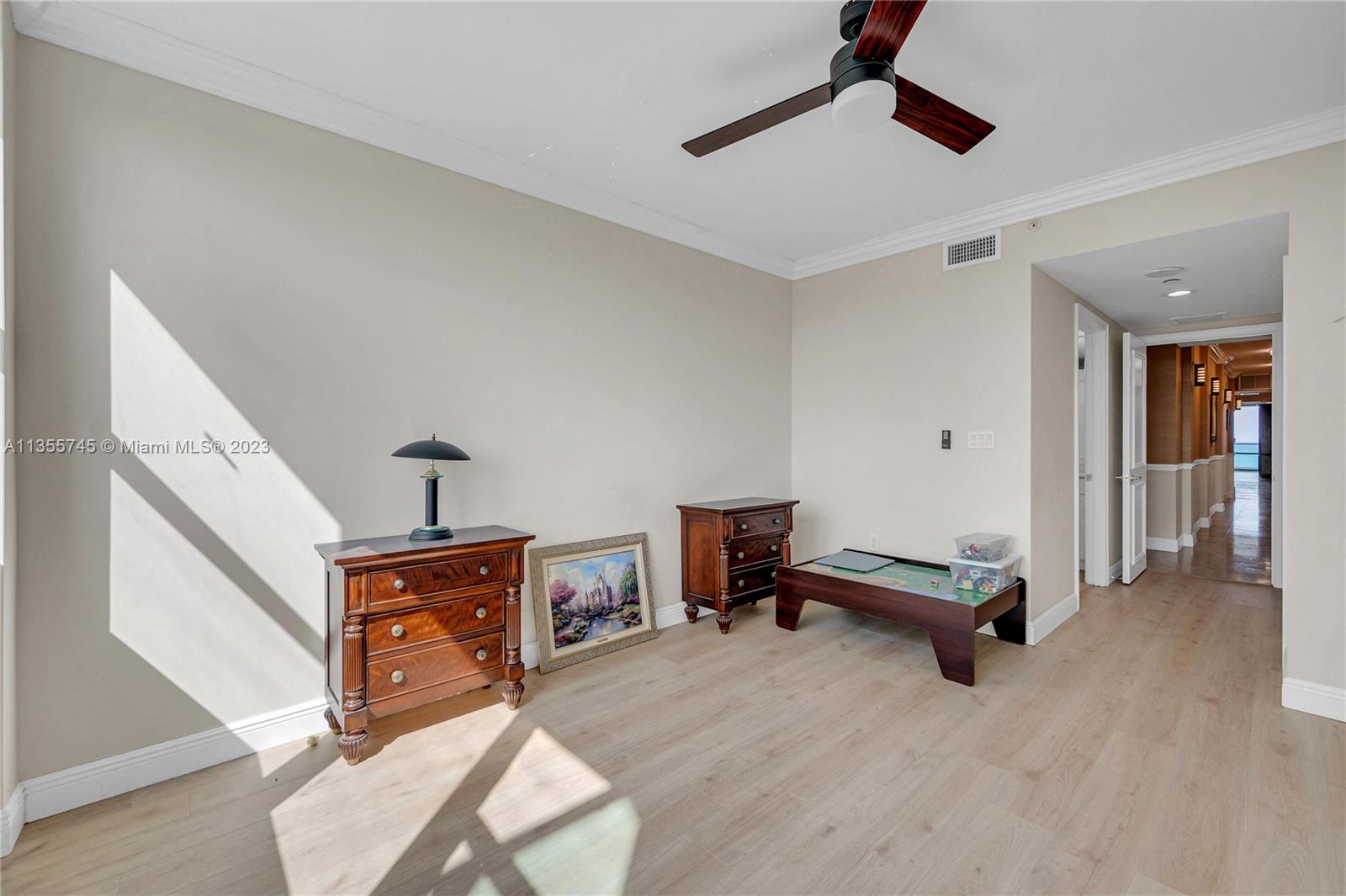 powder room in main hallway to den, guest room and kitchen