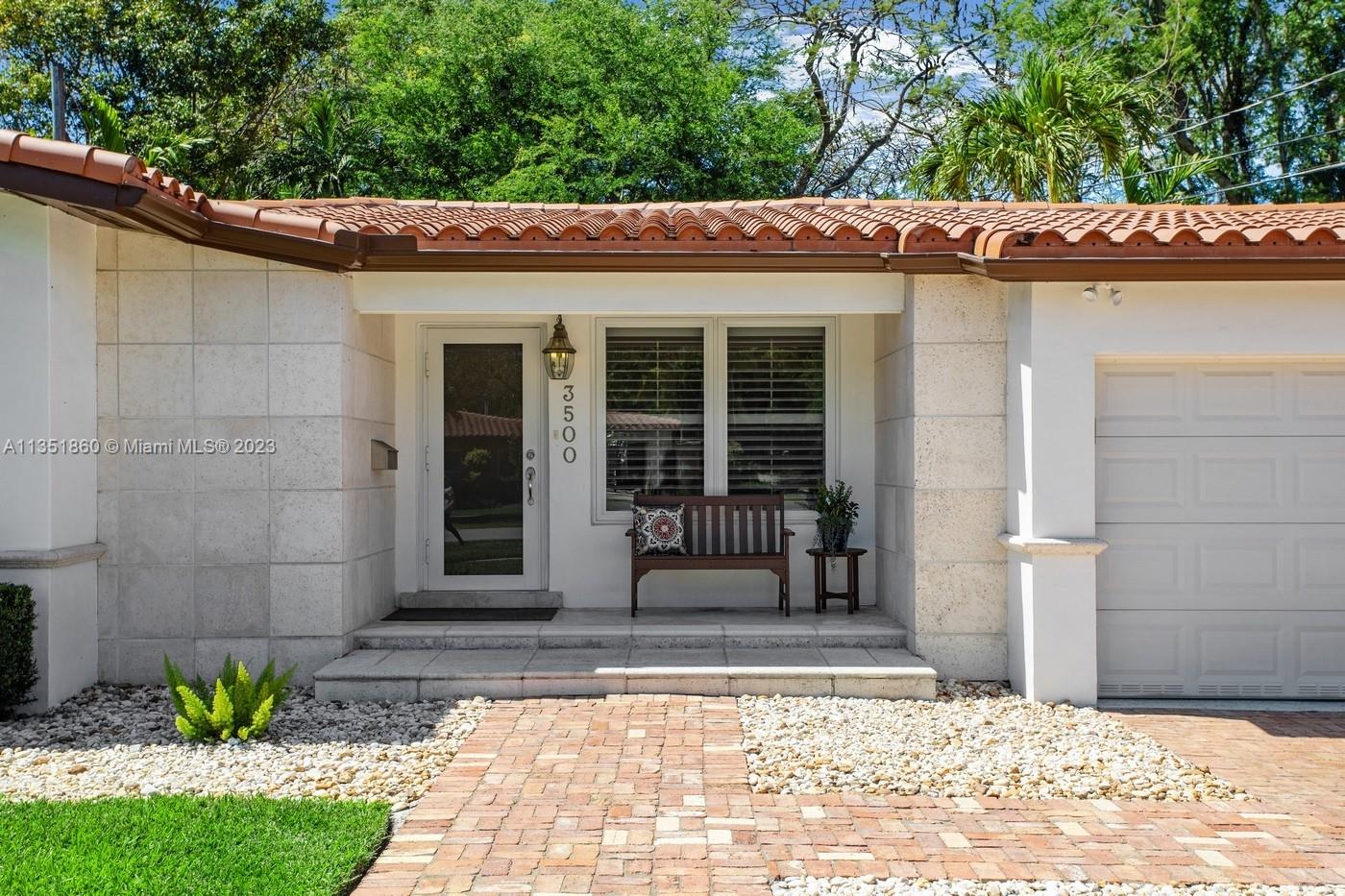Charming and elegantly updated Gables gem! Enter into this beautiful move in ready, open floor plan to experience the perfect ambiance offering Impact windows /doors, immaculate neutral travertine and hardwood floors, plantation shutters throughout and a new Carrier A/C with u.v. light, new duct work and PVC plumbing. Perfect for intimate gatherings with an over sized island with seating, temperature controlled wine cooler, stainless steel appliances ,wood and granite kitchen, including a full house Generac generator.  Crown molding with delicately designed sculptured ceilings, recessed lighting and a full 2 car garage make this the perfect oasis to include outdoor relaxation on the Chicago brick patio among mature and meticulously manicured foliage with a park like setting. Welcome Home!