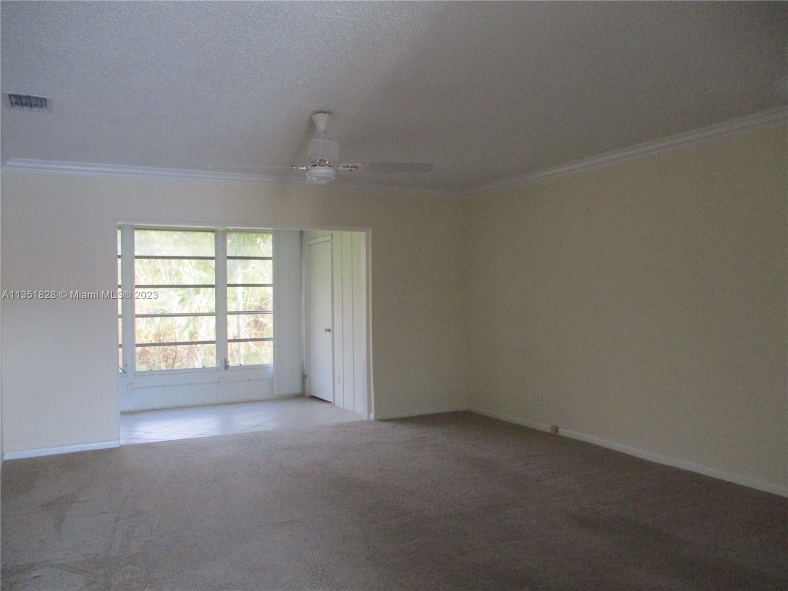 VIEW FROM FRONT DOOR INTO LIVING ROOM WITH CROWN MOLDING THROUGHOUT