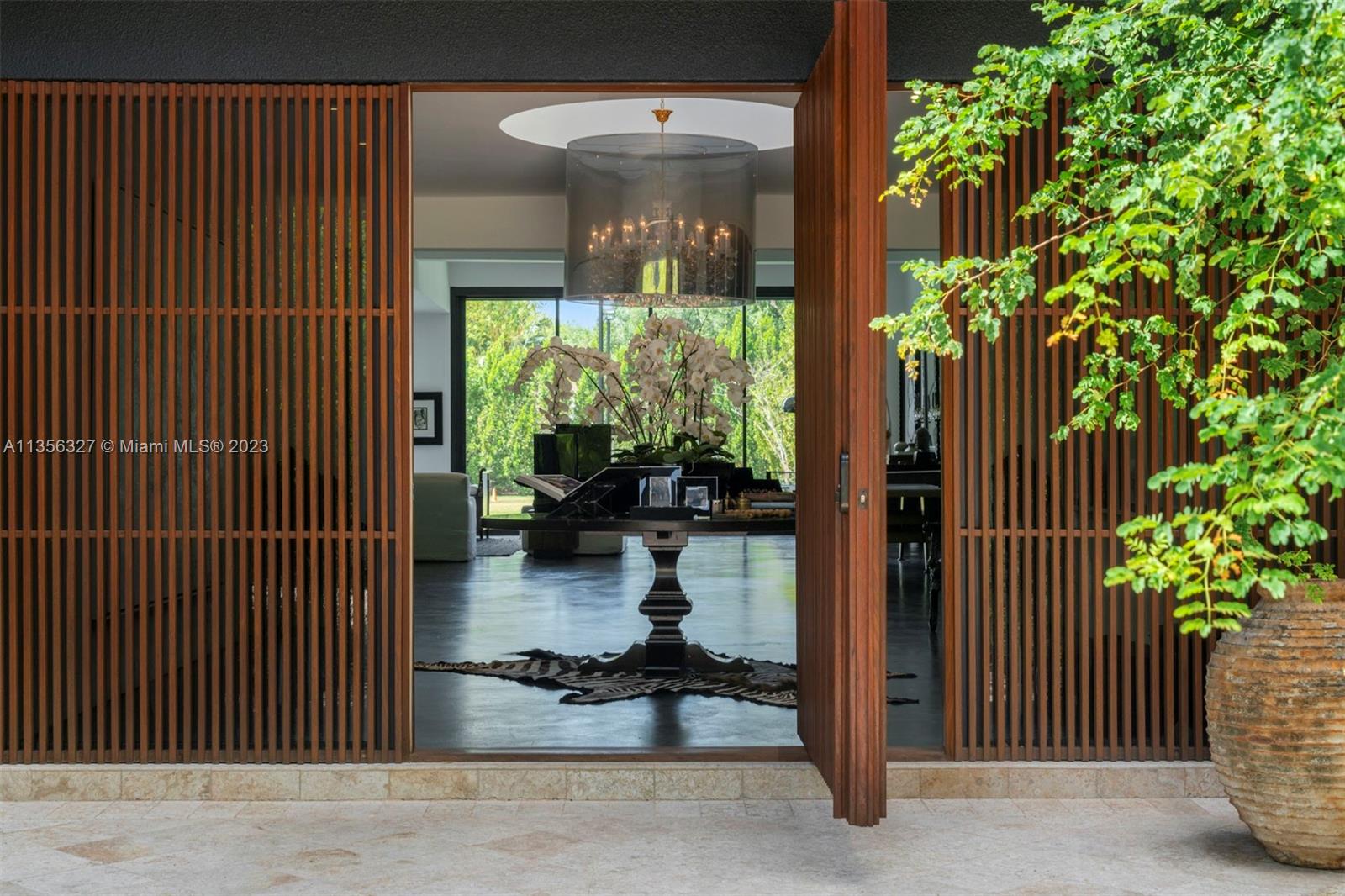 This exceptional 7,838 Sq Ft residence, completely renovated in 2021 with 6 bedrooms and 6.5 baths, merges modern and contemporary architecture featuring a seamless floor plan with walls of sliding glass doors that offer stunning views of manicured landscaping, a resort-style pool and basketball/tennis court. Spacious living areas are the centerpiece of this home, integrating a state-of-the-art kitchen with the dining and family areas, creating a blend of ambience and luxury living.The main suite has large walk-in closet and spa-like bath. Built with incredible attention to detail, the home has epoxy cement and wood floors, new high impact windows, modern black mirrored doors, and solar roof tiles. The 3-car garage, vast driveway, and great location complete this one-of-a-kind masterpiece.