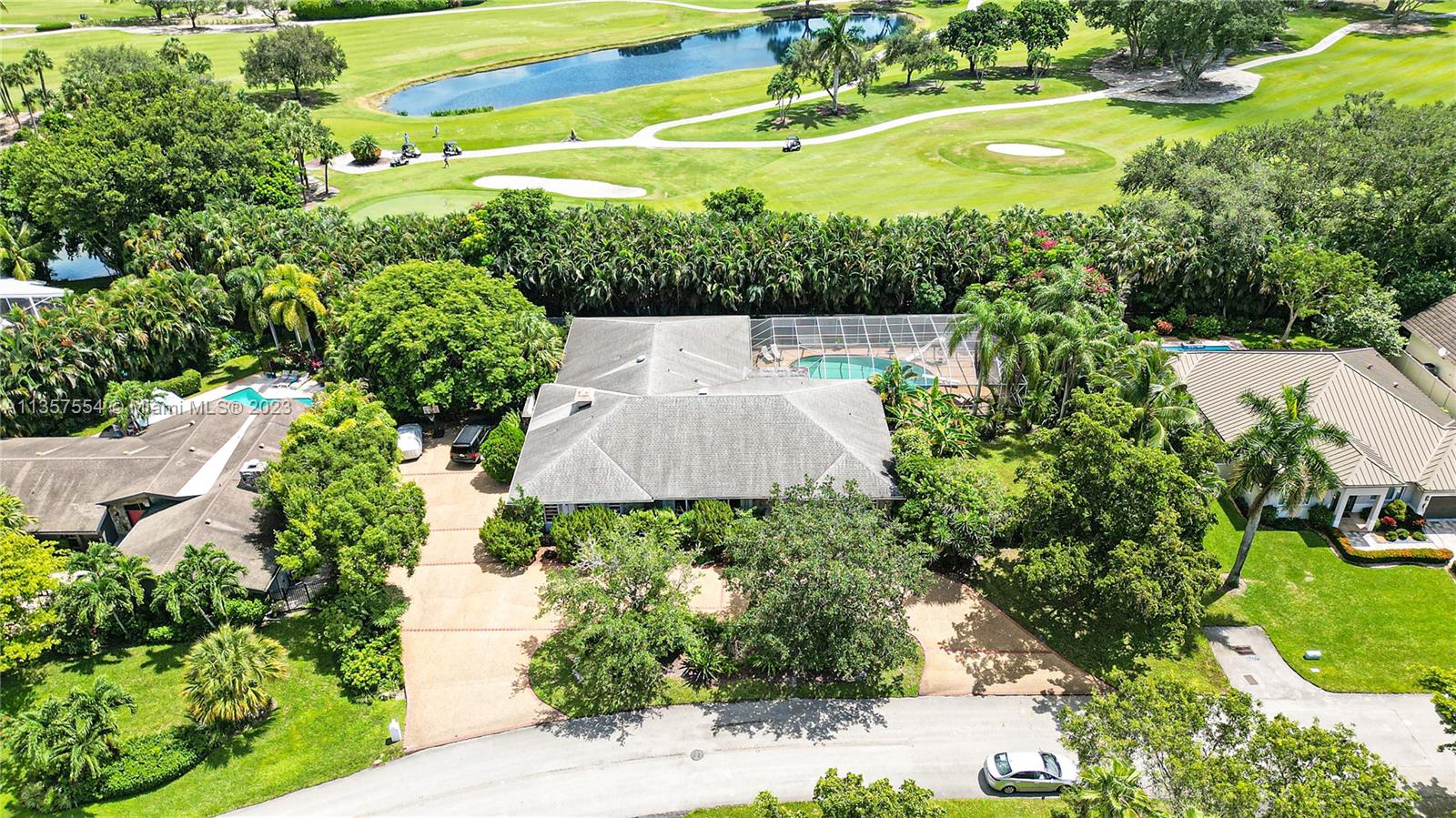 Custom built one story spacious and luxurious four bedroom four bathroom home with vaulted ceilings that is situated on a double lot with a large fenced backyard. Screened, heated pool with slide and diving board along with a separate heated jacuzzi. Marble floors throughout with an elevated carpeted living room. An absolutely spectacular home!