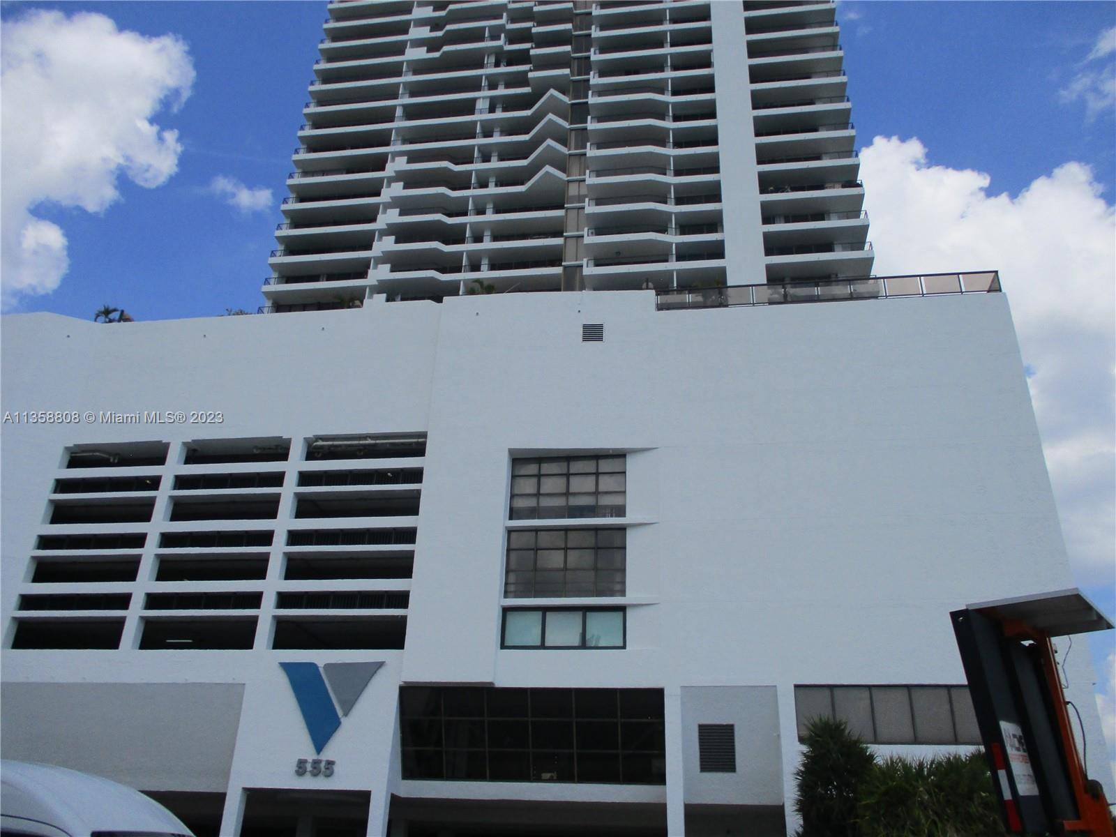 Front of Building, Pools, Tennis Courts, and Restaurant above Garage