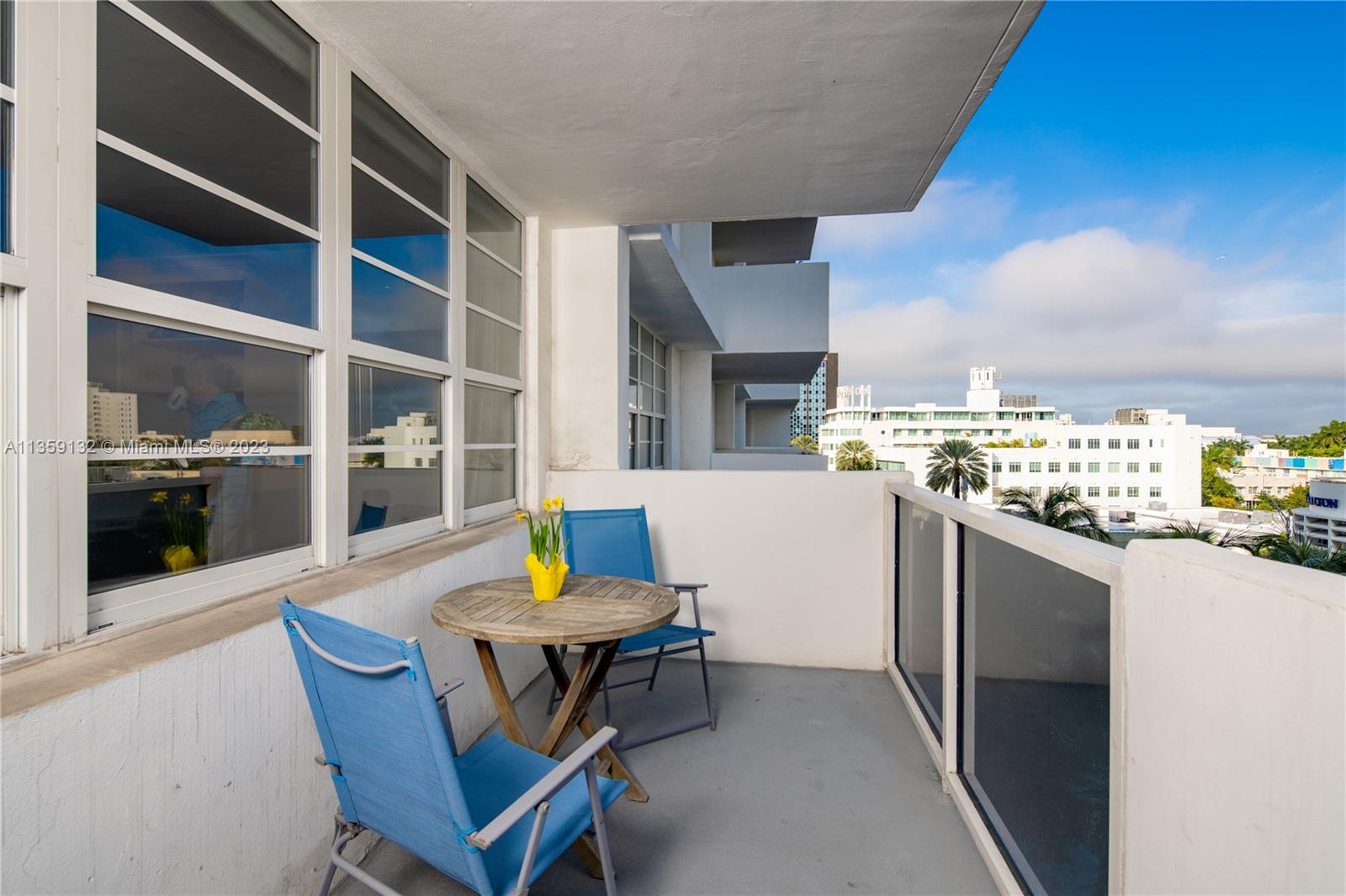 Photo showing large size of the balcony with two chairs and a table.