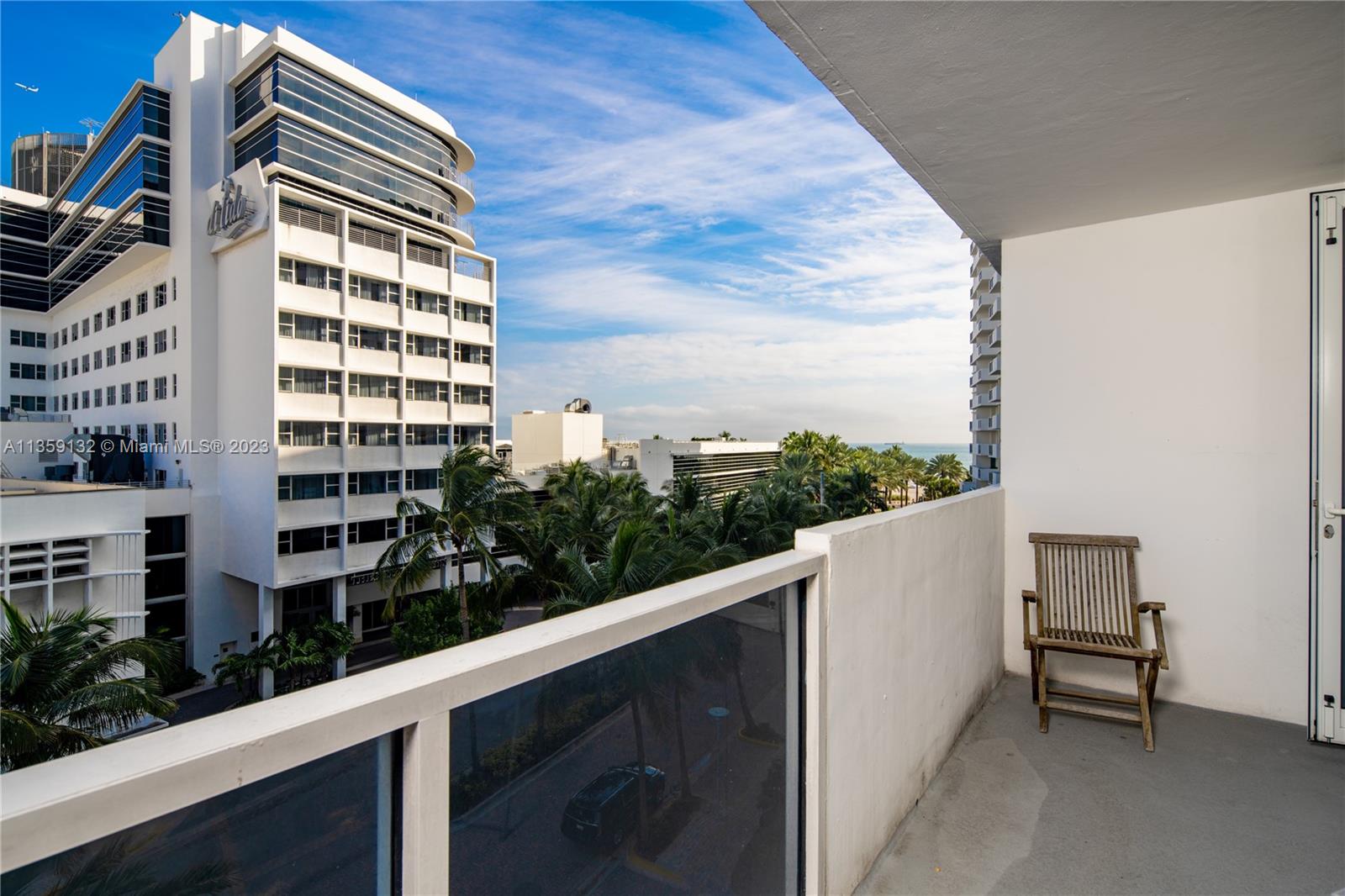 Photo showing large size of the balcony with two chairs and a table.