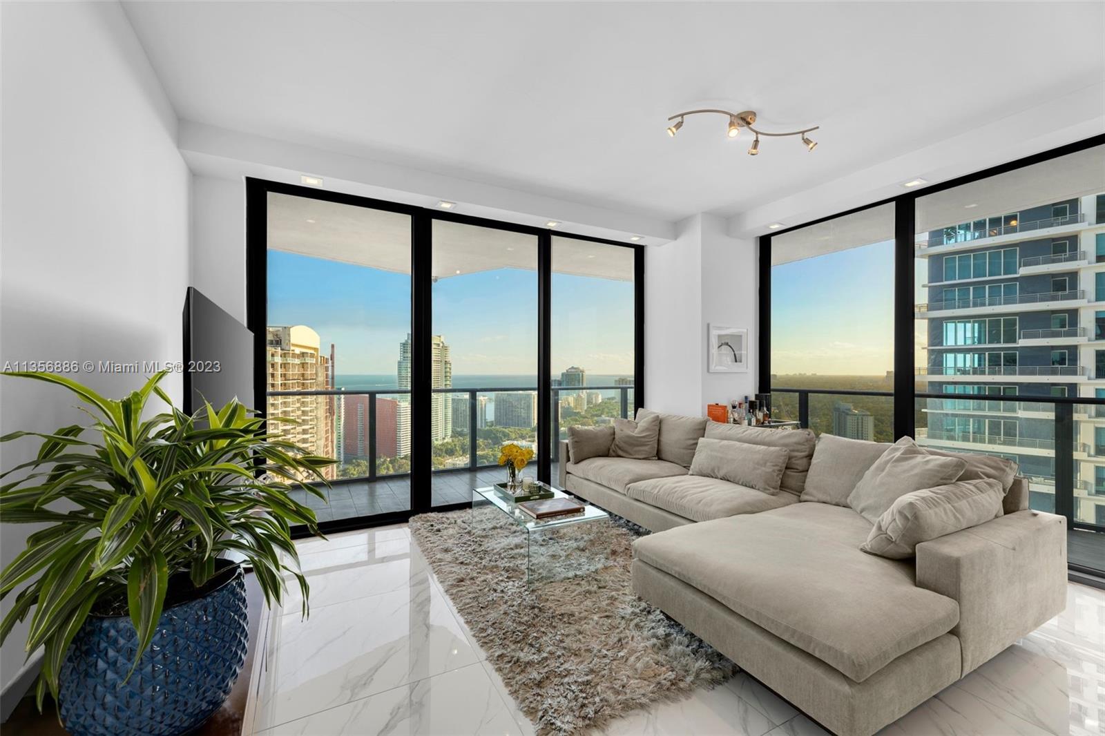 This beautiful and expansive apartment features three bedrooms and two full and one-half bathrooms, radiating refinement and comfort. Its exquisite floor-to-ceiling windows welcome an abundance of natural light, showcasing spectacular cityscape and bay views. The primary suite's ensuite bathroom boasts a soaking tub, a separate shower, and a dual vanity sink, providing a serene and comfortable retreat. The second bedroom is spacious and its bathroom features a convenient shower/tub combo. A stylish and modern kitchen is equipped with high-end appliances, custom cabinets and a spacious island. Nestled in the heart of the vibrant Brickell neighborhood, this apartment offers the perfect sanctuary to call home while fully immersing oneself in the lively and dynamic community that surrounds it.