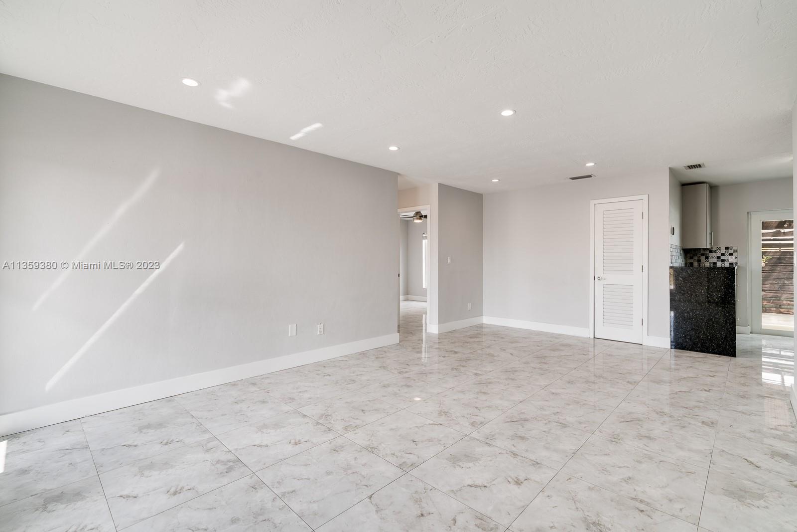 Here is the view of the livingroom from the front door. Notice the whole unit has tile floors and the floors are all on one level. Also notice the recessed lights in the ceiling.