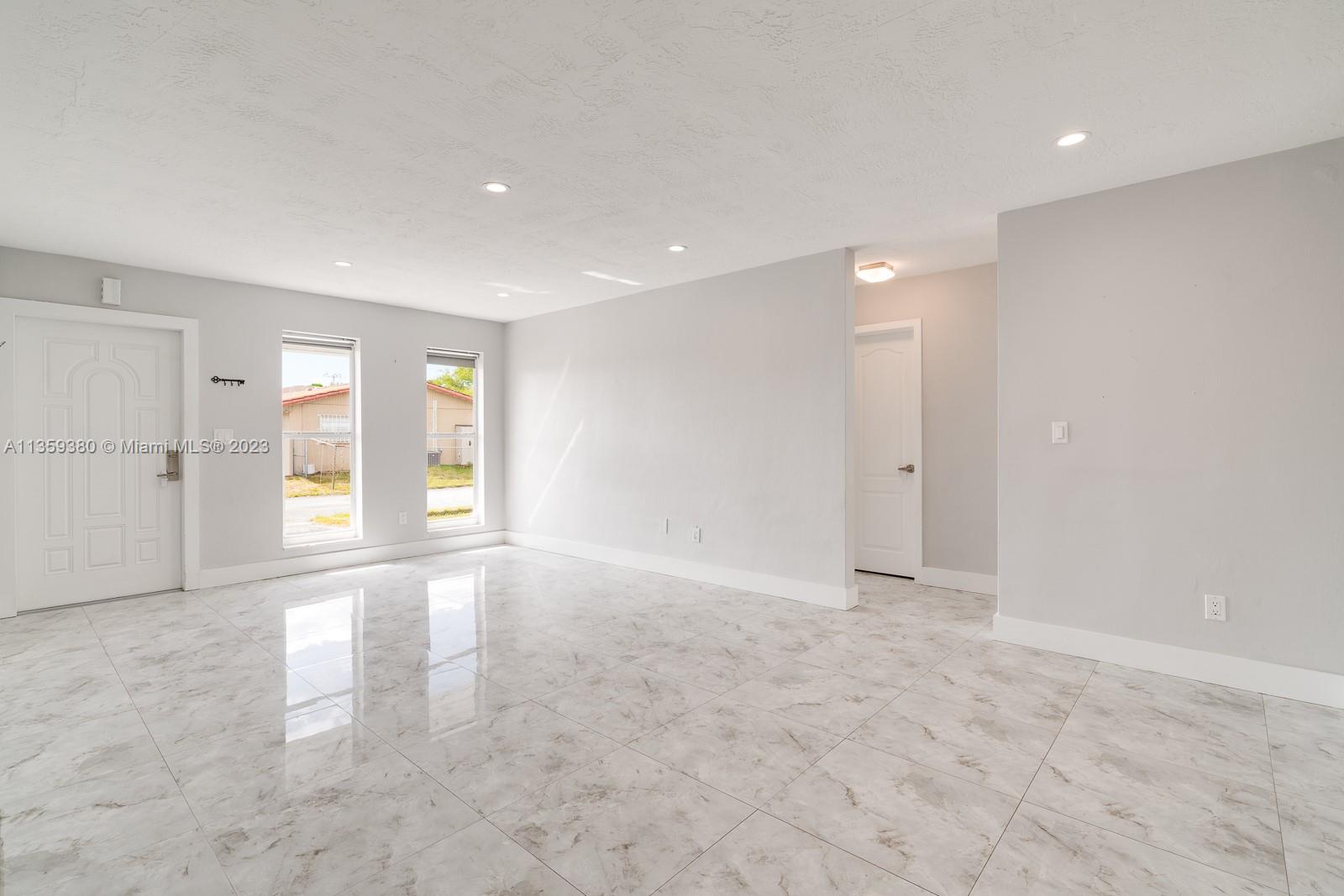 This view is from SE corner of the livingroom looking towards the North side of the livingroom and the hallway that leads to the updated Bathroom and the Primary and second Bedroom.