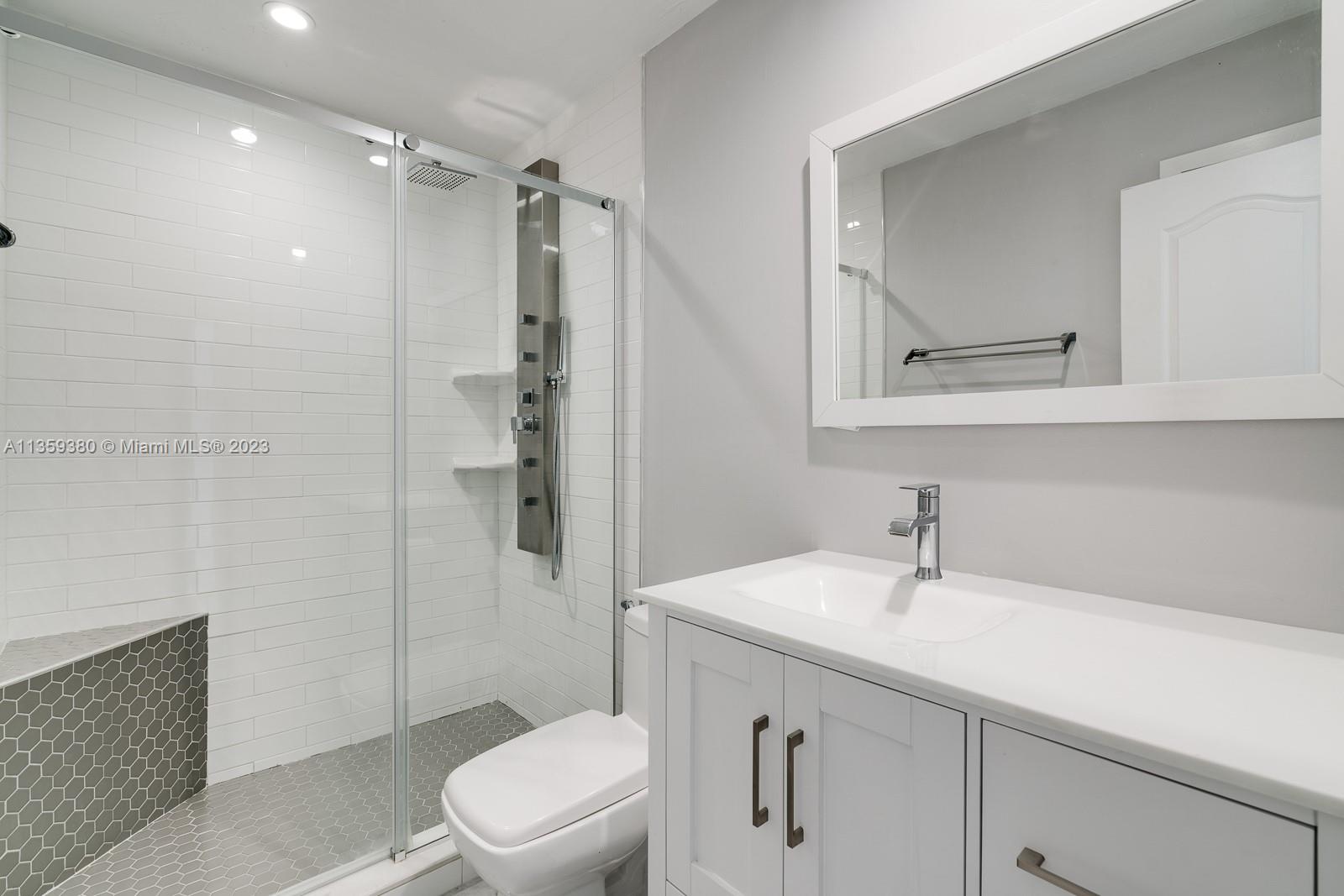 WOW! What a nice shower with the sitting bench, the multi shower heads and the shelving for the soaps and shampoos!