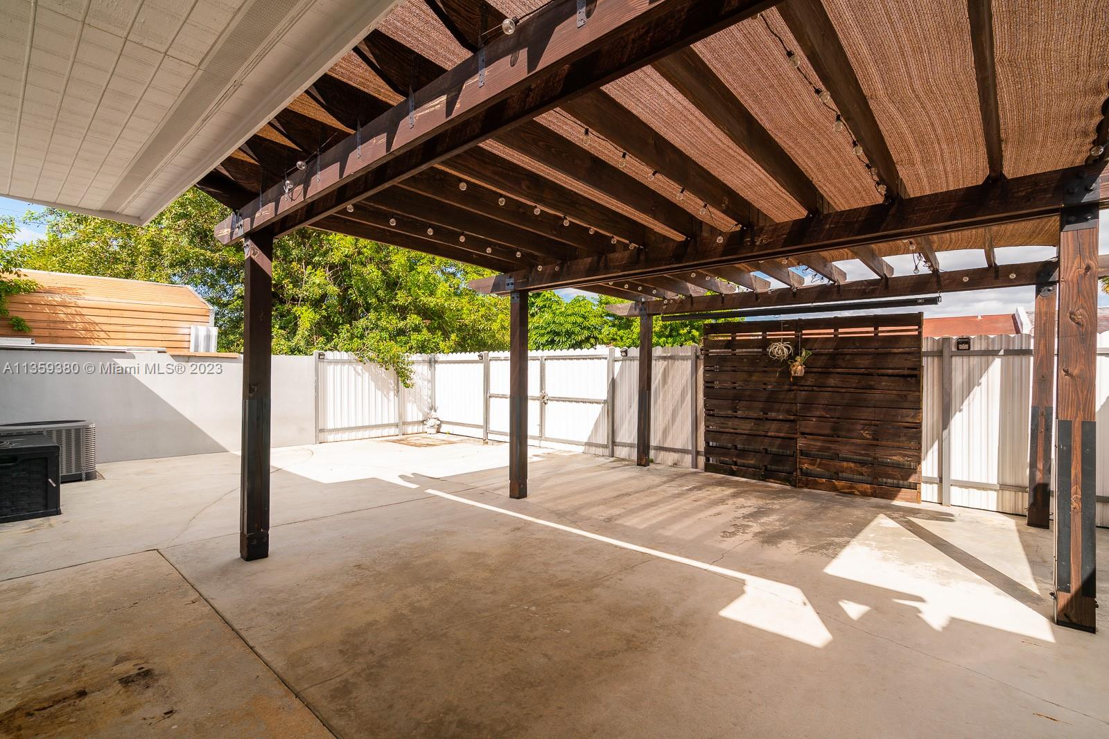 The patio has this beautiful, well built wood beamed trellis with a canvas cover used for shading half of the patio.