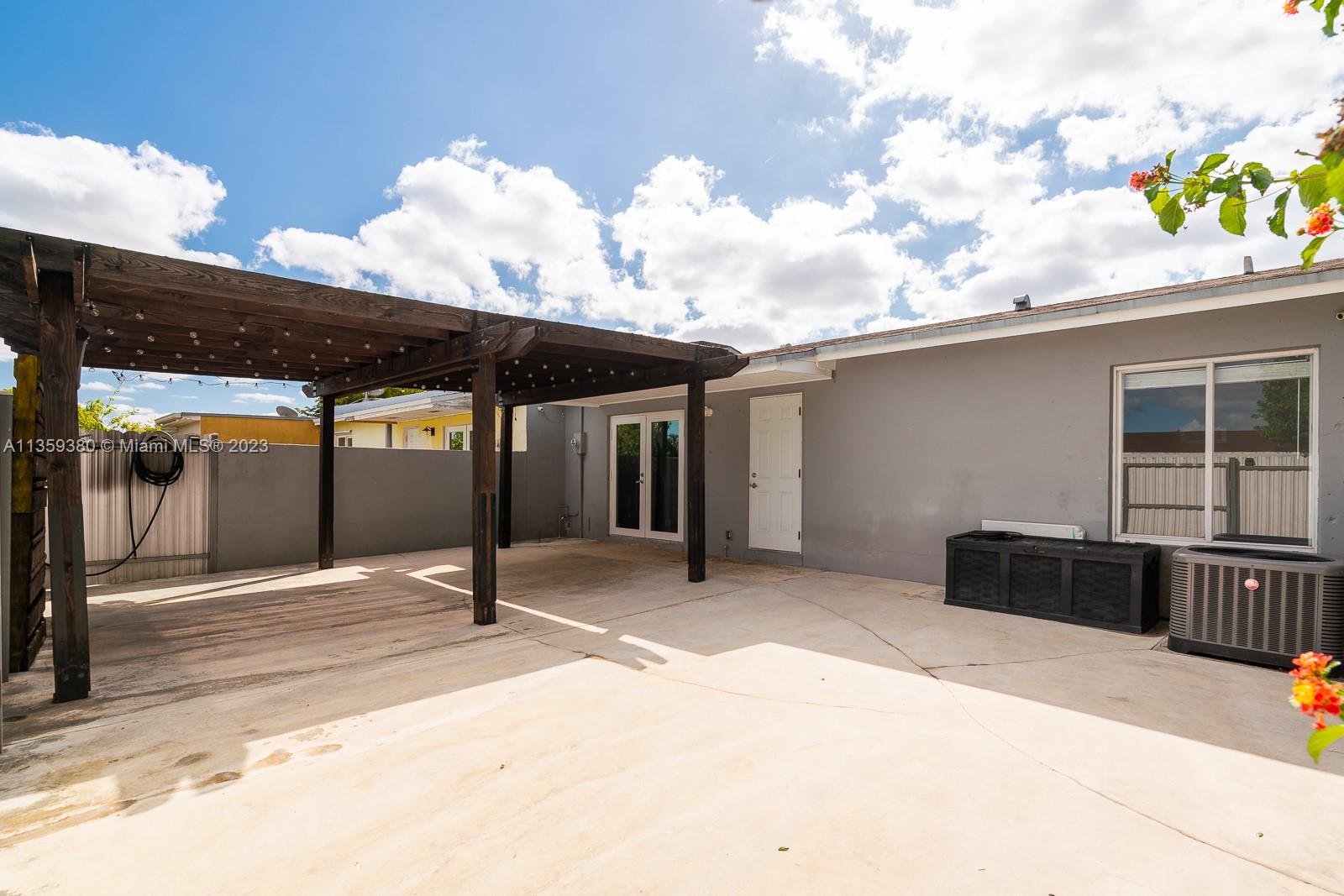 Here is your view showing the back of your villa. The white door leads to a storage closet. The Impact French Doors lead into the kitchen area.