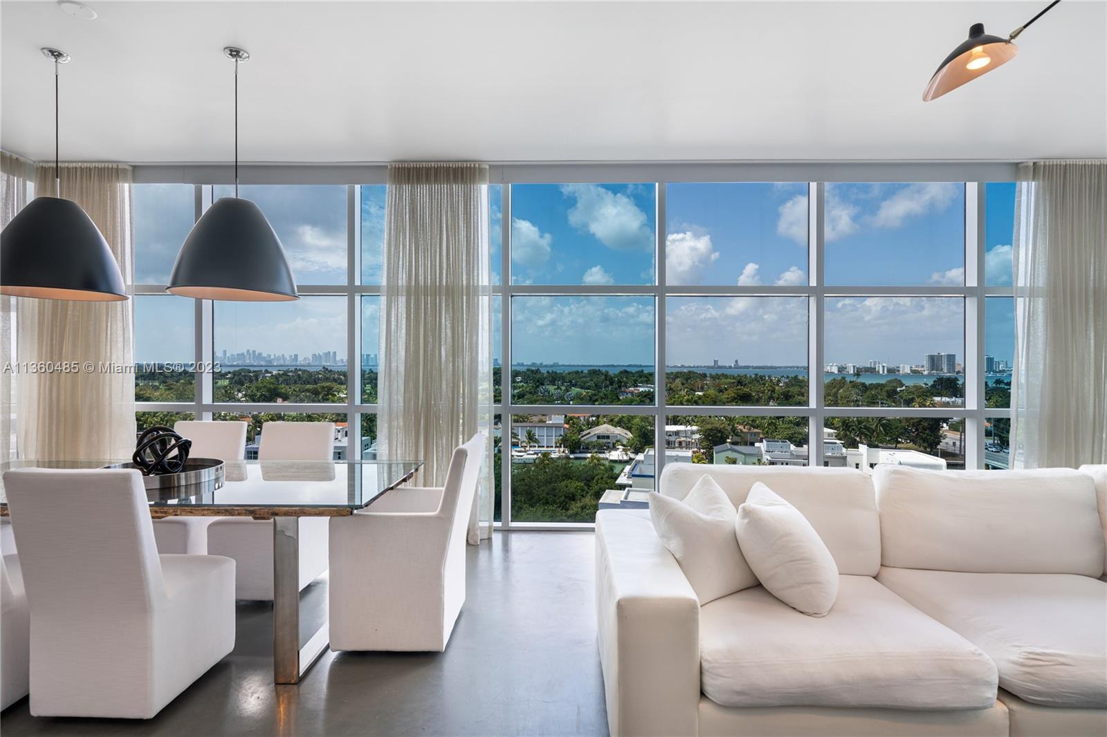 Another Collectable Property! Discover an extraordinary living experience at Aqua, located within the serene enclave of Allison Island in Miami Beach. This exquisite, gated community offers residents a tranquil oasis with a plethora of amenities. Take a refreshing dip in the stunning pool, rejuvenate at the health and wellness spa, stroll along the walking paths, or grab a bite at the Aqua café. This stunning property has four generously sized bedrooms, with ensuite bathrooms. The heart of the home is centered around a spacious living area, featuring a cozy living space, elegant dining, an open chef's kitchen, and a convenient office nook. Soaring 10-foot ceilings and expansive glass-framed walls offer breathtaking views of the Miami skyline and the most mesmerizing sunsets.