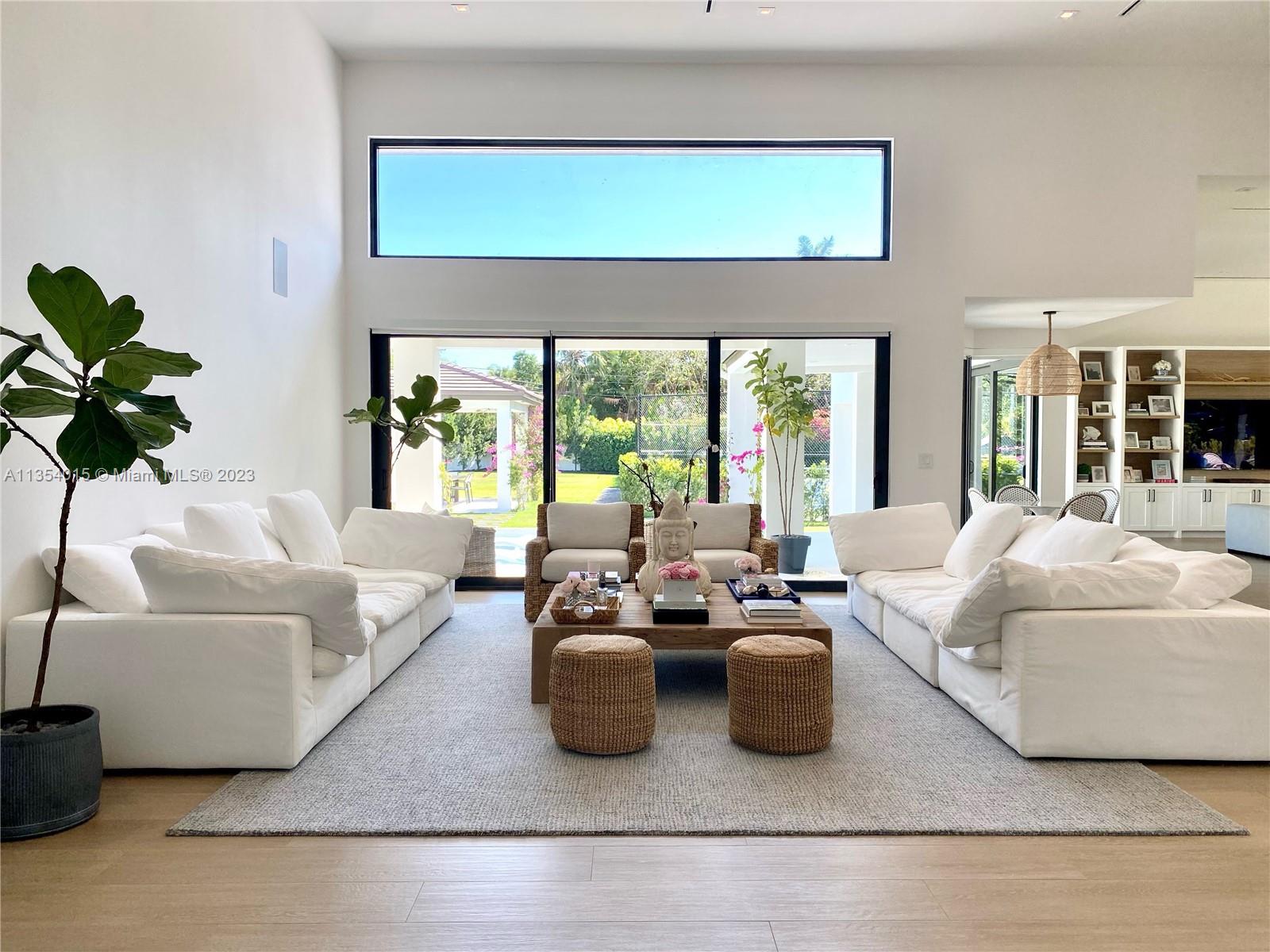 Spectacular Gated Home on Pine Drive in sought after Ponce Davis! 6 bdrms/5.5 bthrms w/ 2 car garage! Over an acre! Completely Remodeled in 2021, including security cameras, Elan automation system, impact windows, custom built-in cabinetry, wood tile floors, HVAC system, new roof, Tesla charger, heated pool, gazebo, tennis/pickleball court, lush landscaping, well water for sprinklers, poured concrete driveway! Generator hook-up, 6 bdrms (2 of which are currently used as an office + staff room, 5 full bthrms (includes cabana bath), 1 half bath, Gourmet Kitchen w/ top of the line SS appliances + walk-in pantry, laundry room, large Master Bedroom Suite w/ soaking tub + frameless glass rain shower w/ Dornbracht fixtures throughout. FHP Police exclusively patrolling Ponce Davis homes!!