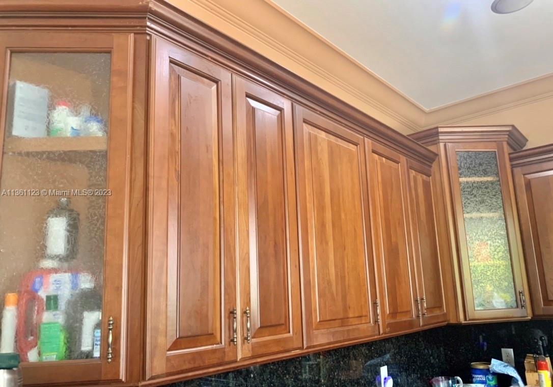 Beautiful wood cabinets with some glass accents